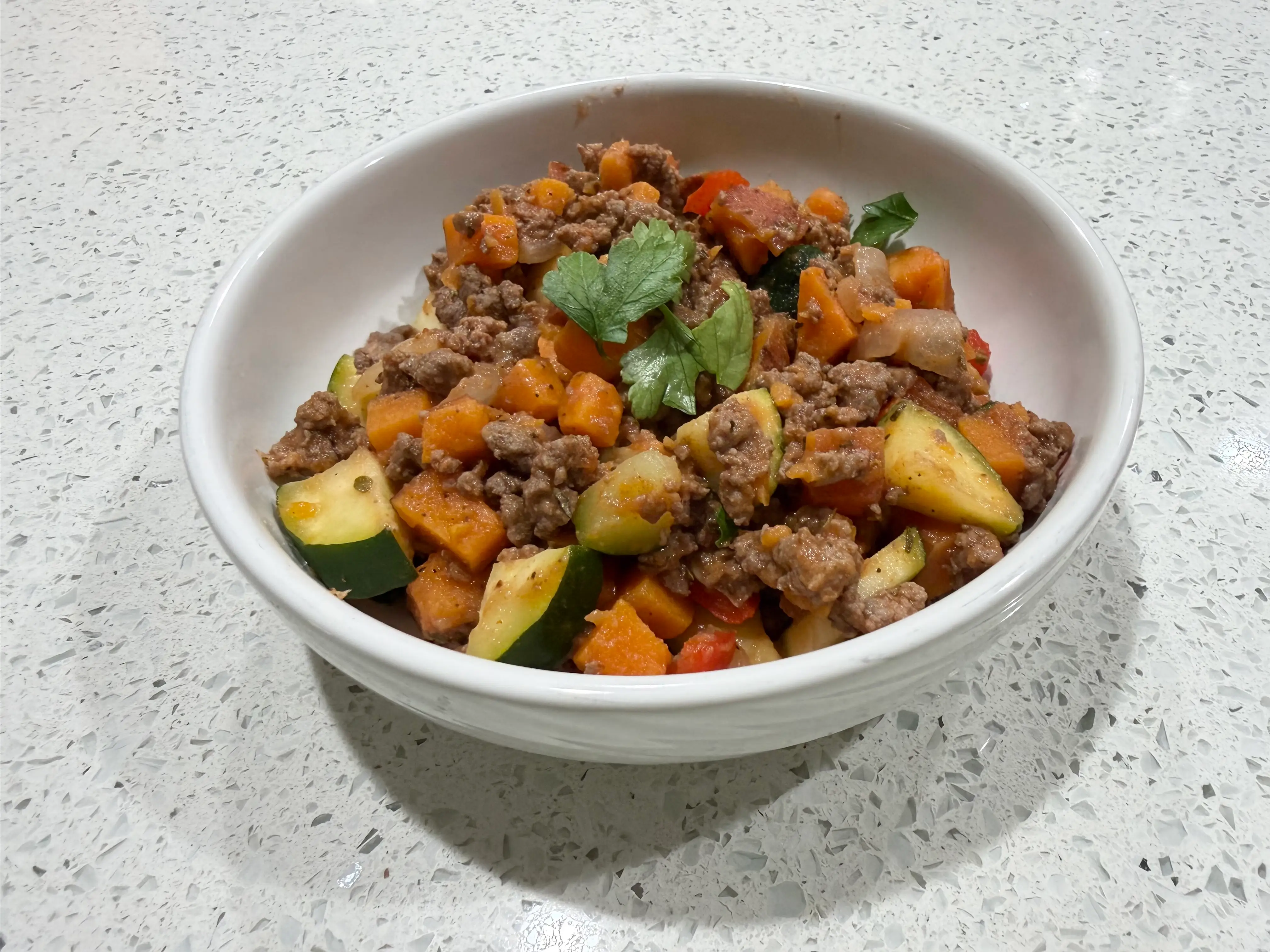 bowls of ground meat, chopped veggies, topped with parsley