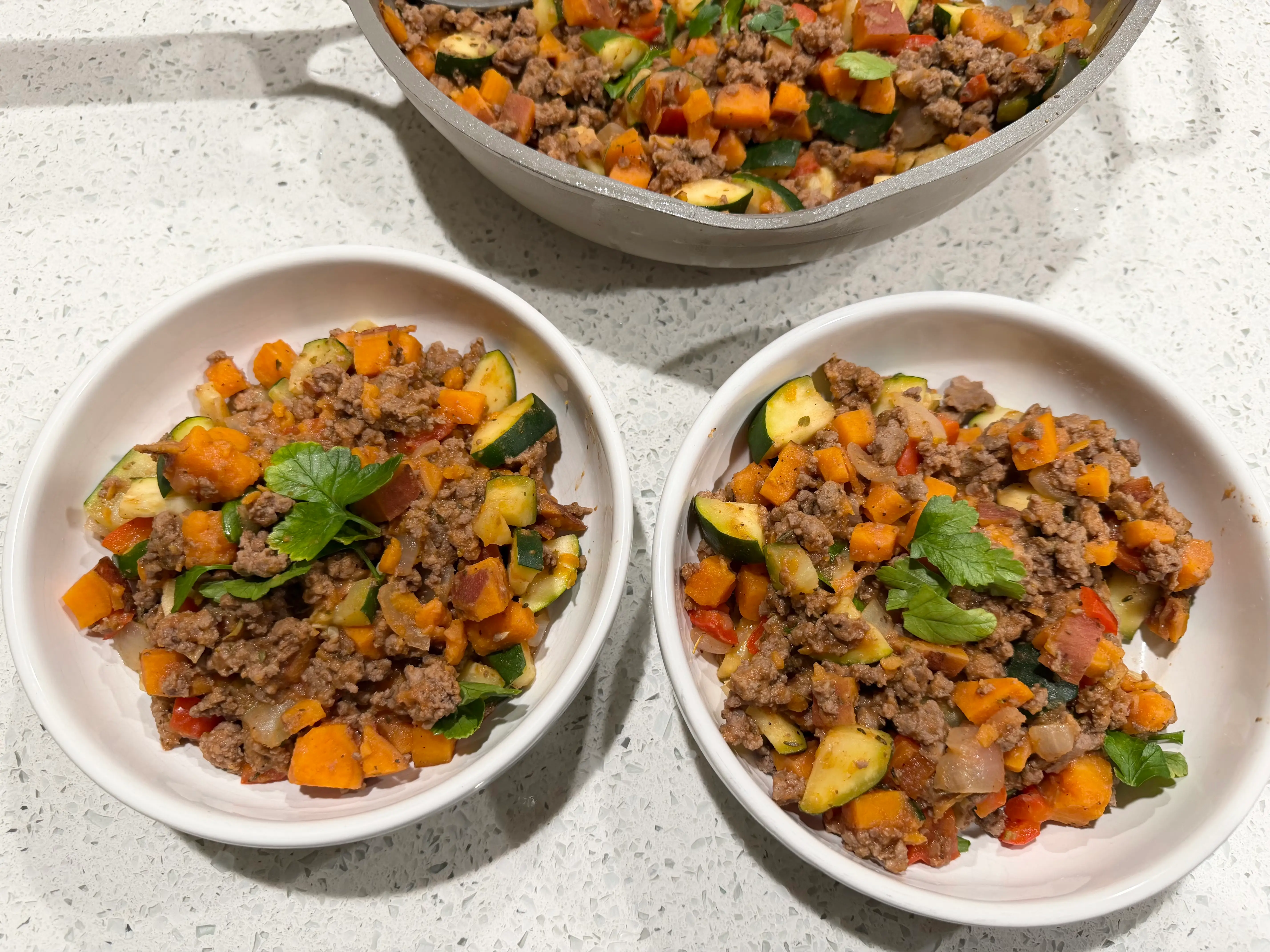 bowls of ground meat, chopped veggies, topped with parsley