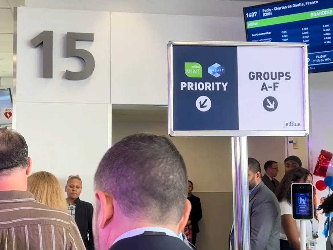 A short line of people boarding in JetBlue's priority lane.