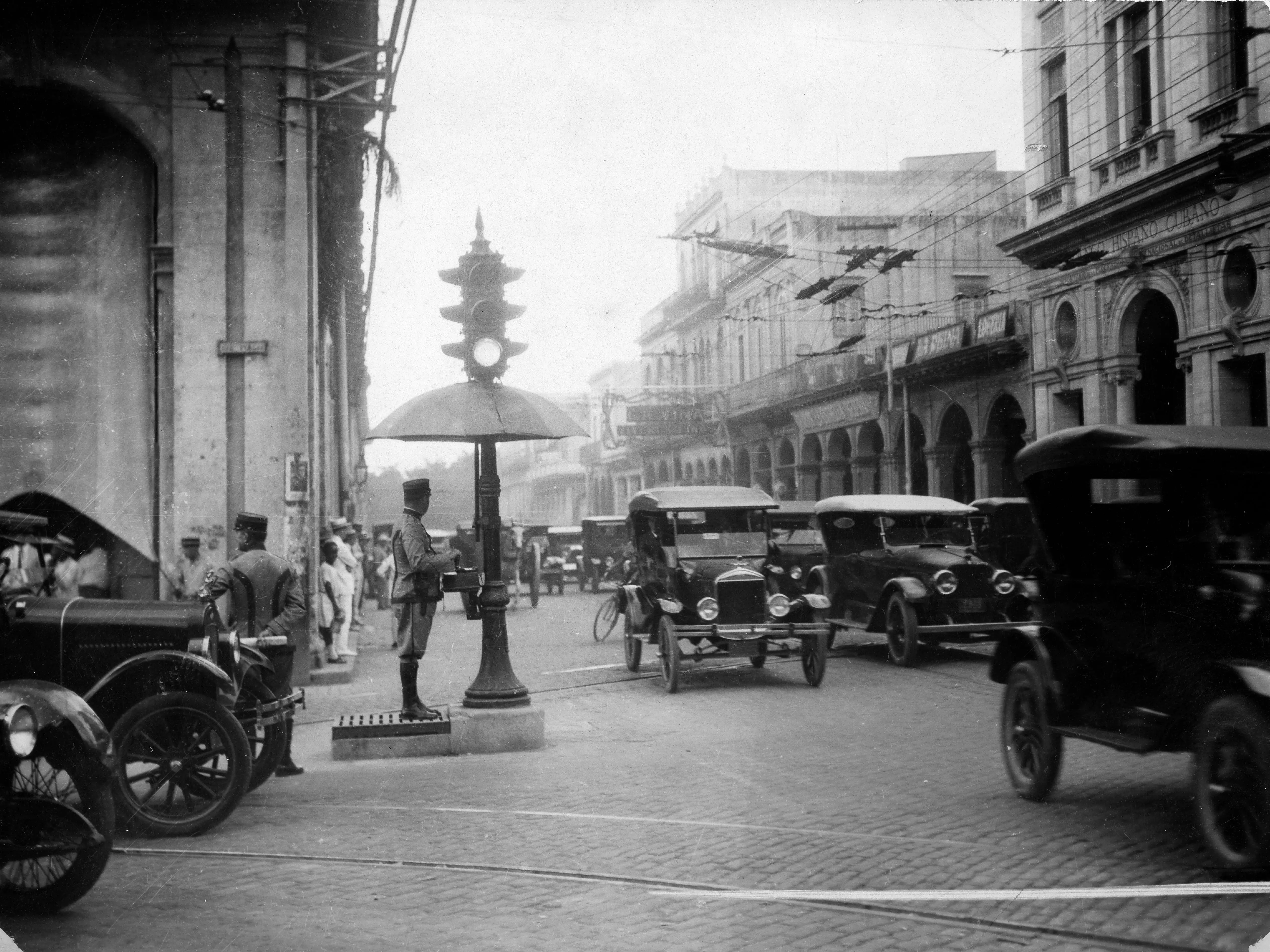 Havana (Habana) Policeman regulating the traffic, standing at a crossroad under an umbrella - 1949