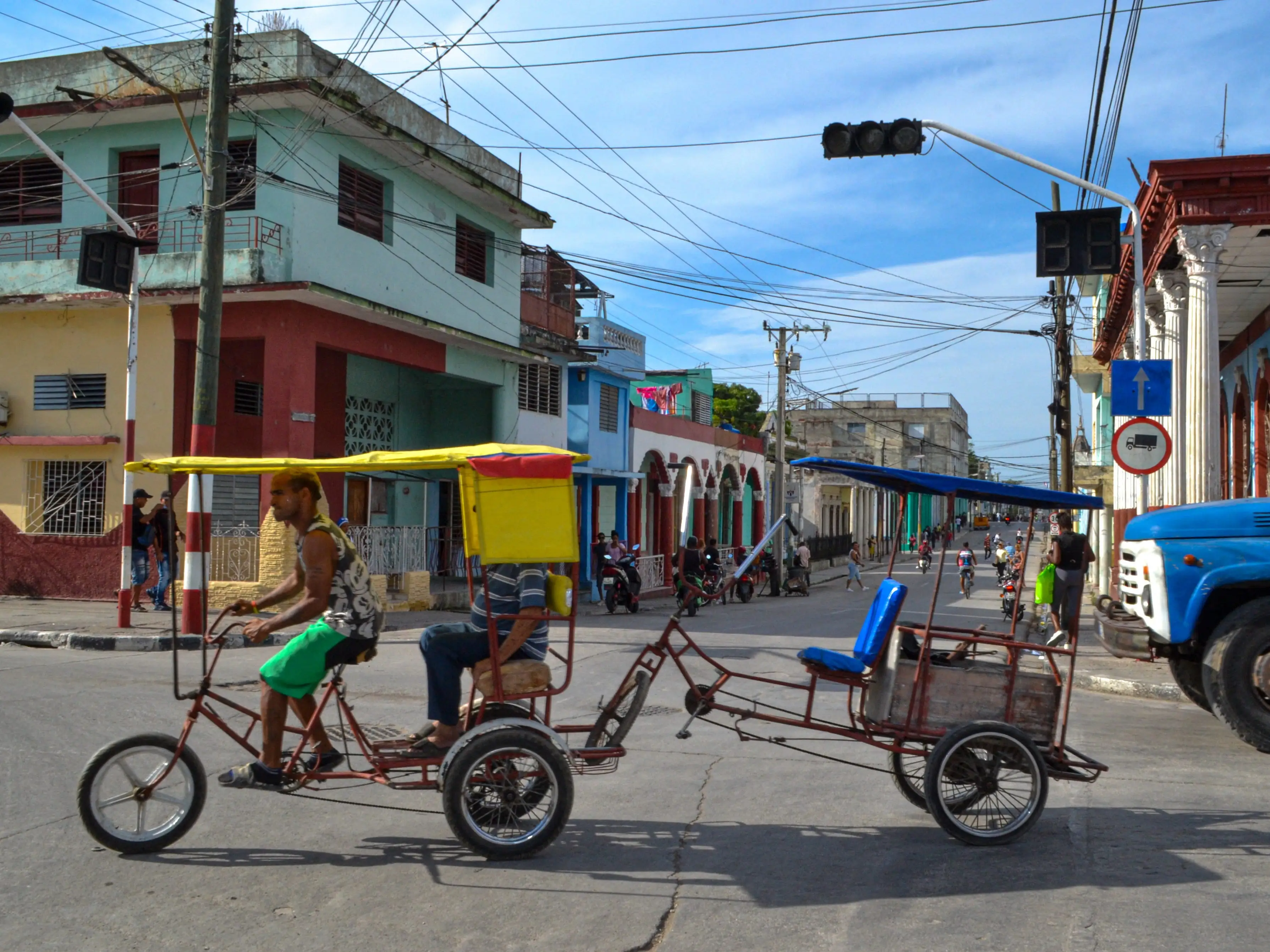 A bicycle taxi rides through an intersection with nonfunctioning traffic lights during a power outage in Guantanamo, Cuba, on August 3, 2026, highlighting the transportation and infrastructure challenges caused by the blackout. Cuba's power grid failed on August 2, 2026, causing another nationwide blackout, a state utility said in a social media post. State-run UNE said there was a 