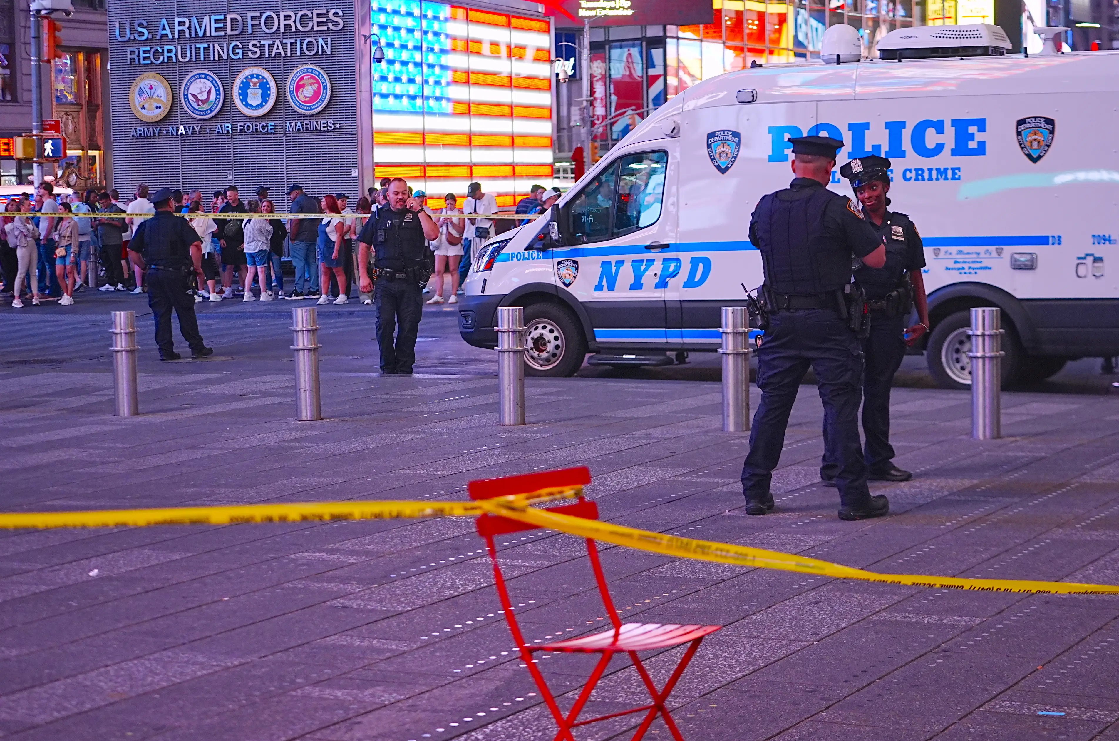 New York Police Department (NYPD) officers investigate the scene after police reportedly shot and wounded a knife-wielding woman accused of stabbing two people near West 42nd Street and Seventh Avenue in Times Square,