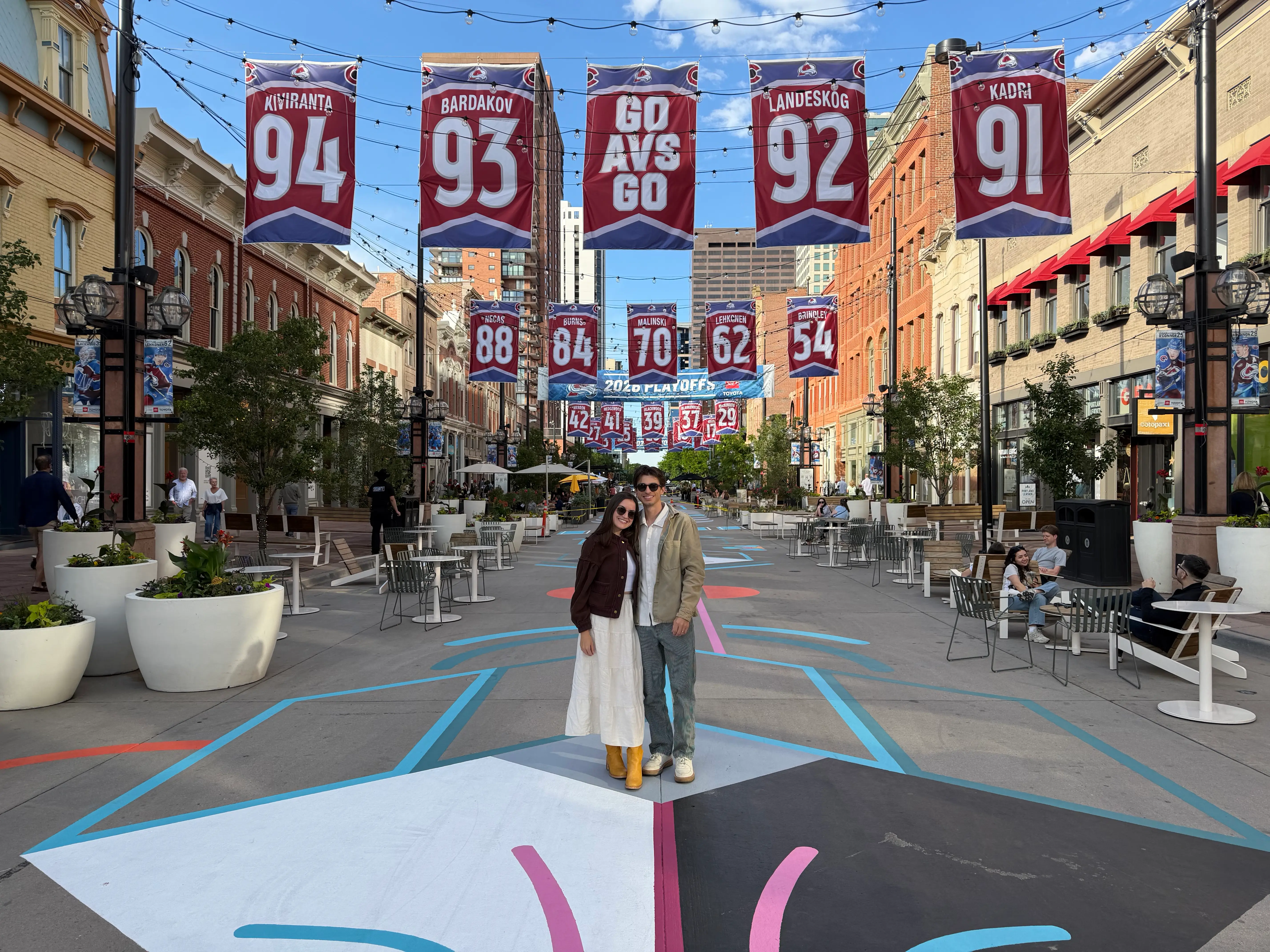 View of downtown denver, two people posing in street