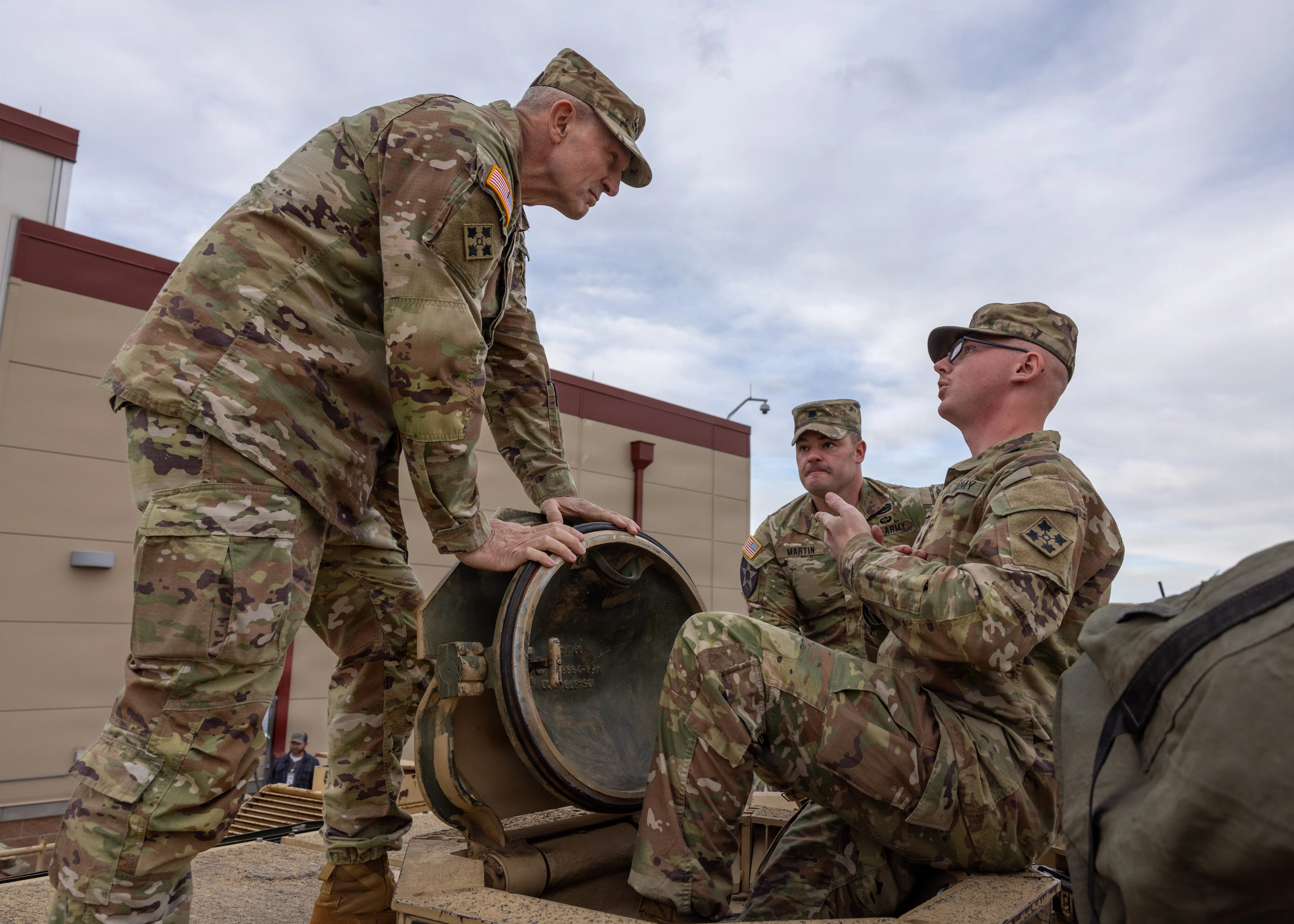 Gen. Randy George, former chief of staff of the Army, seen talking to soldiers on top of a vehicle.