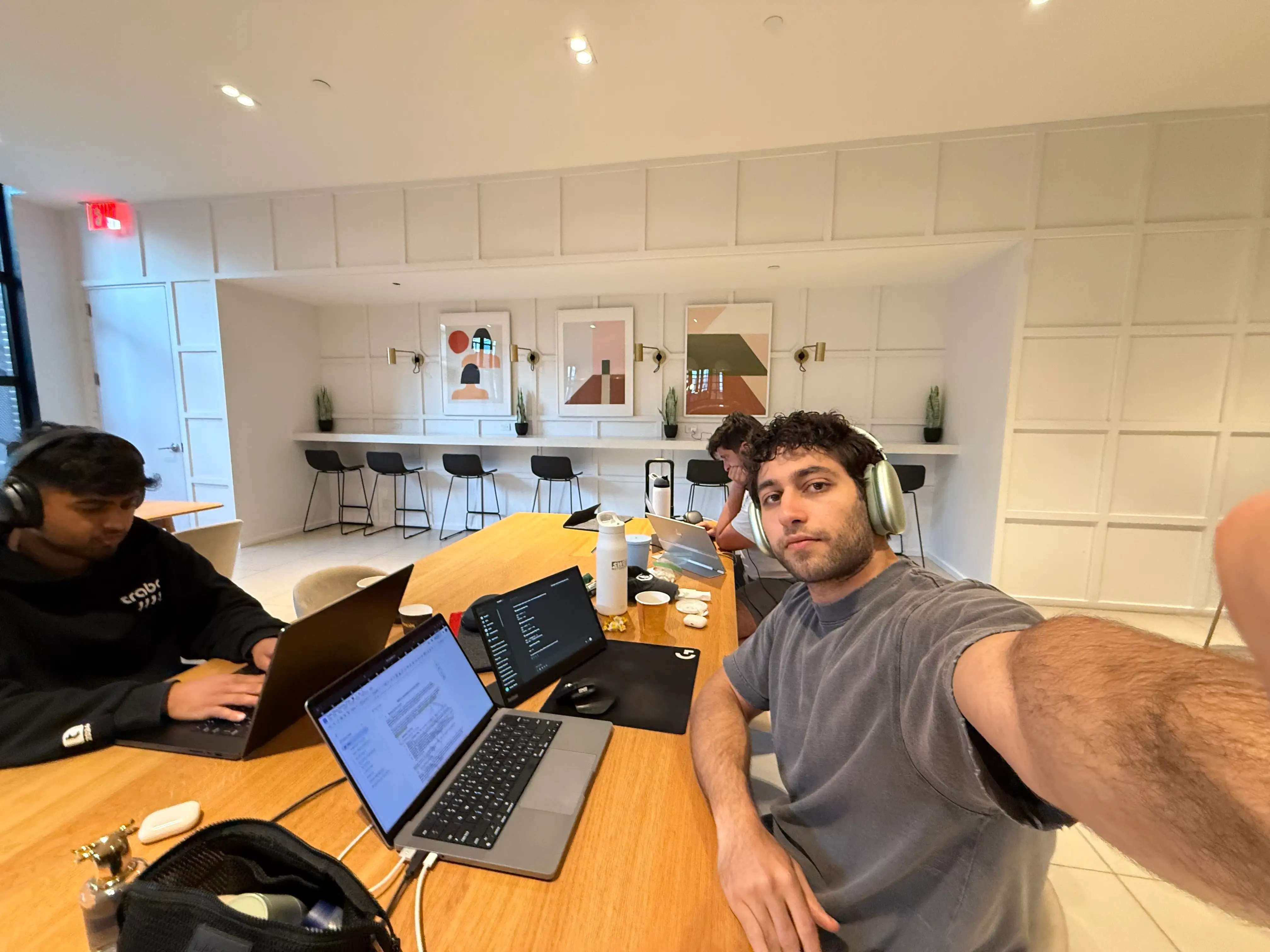 Petra Labs' cofounders are pictured working in one of their apartment lounges.