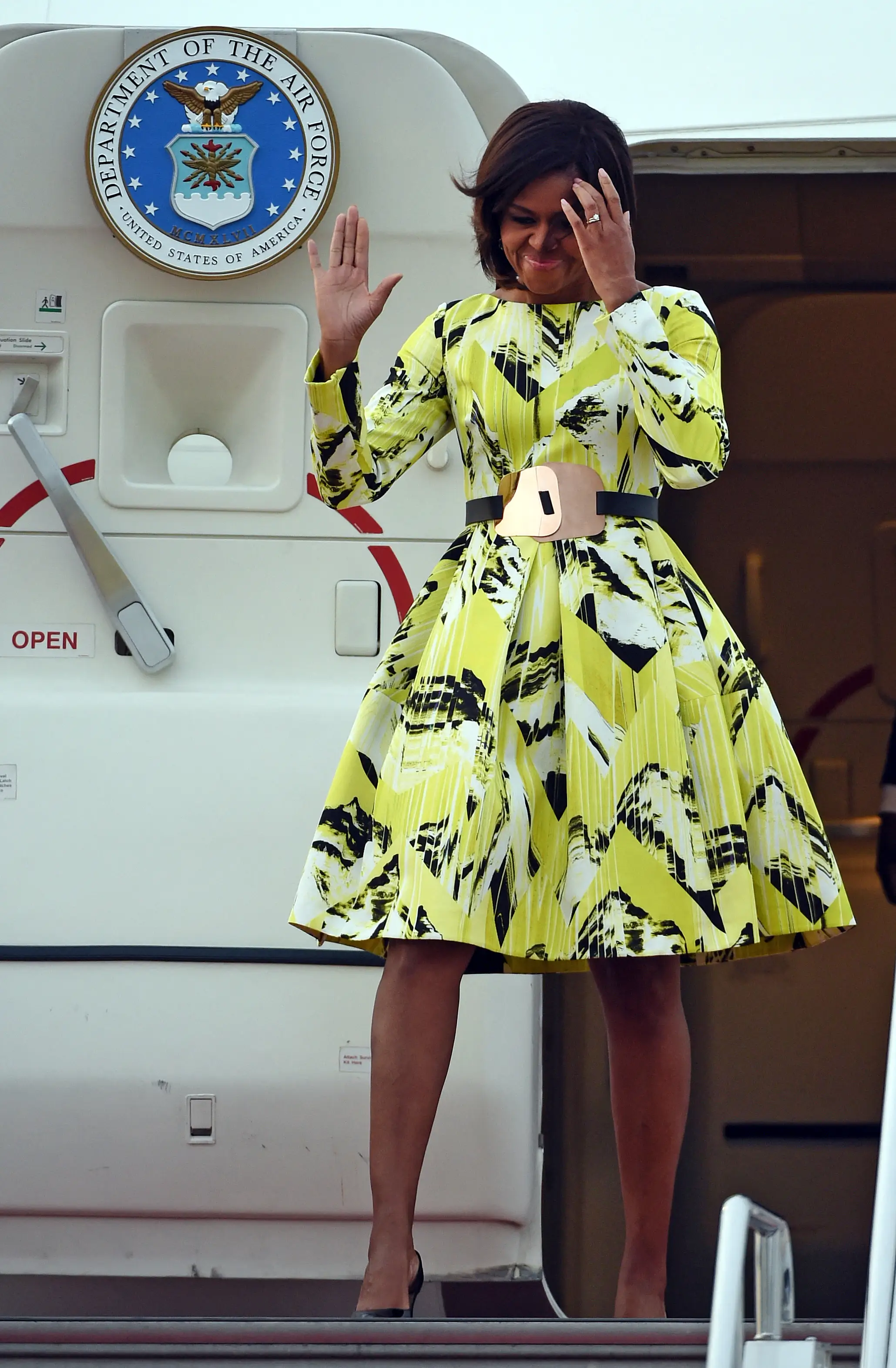US First Lady Michelle Obama waves upon her arrival at Haneda International Airport in Tokyo on March 18, 2015. Michelle Obama arrived in Japan for a three-day visit, as part of a drive to promote girls' education around the world.