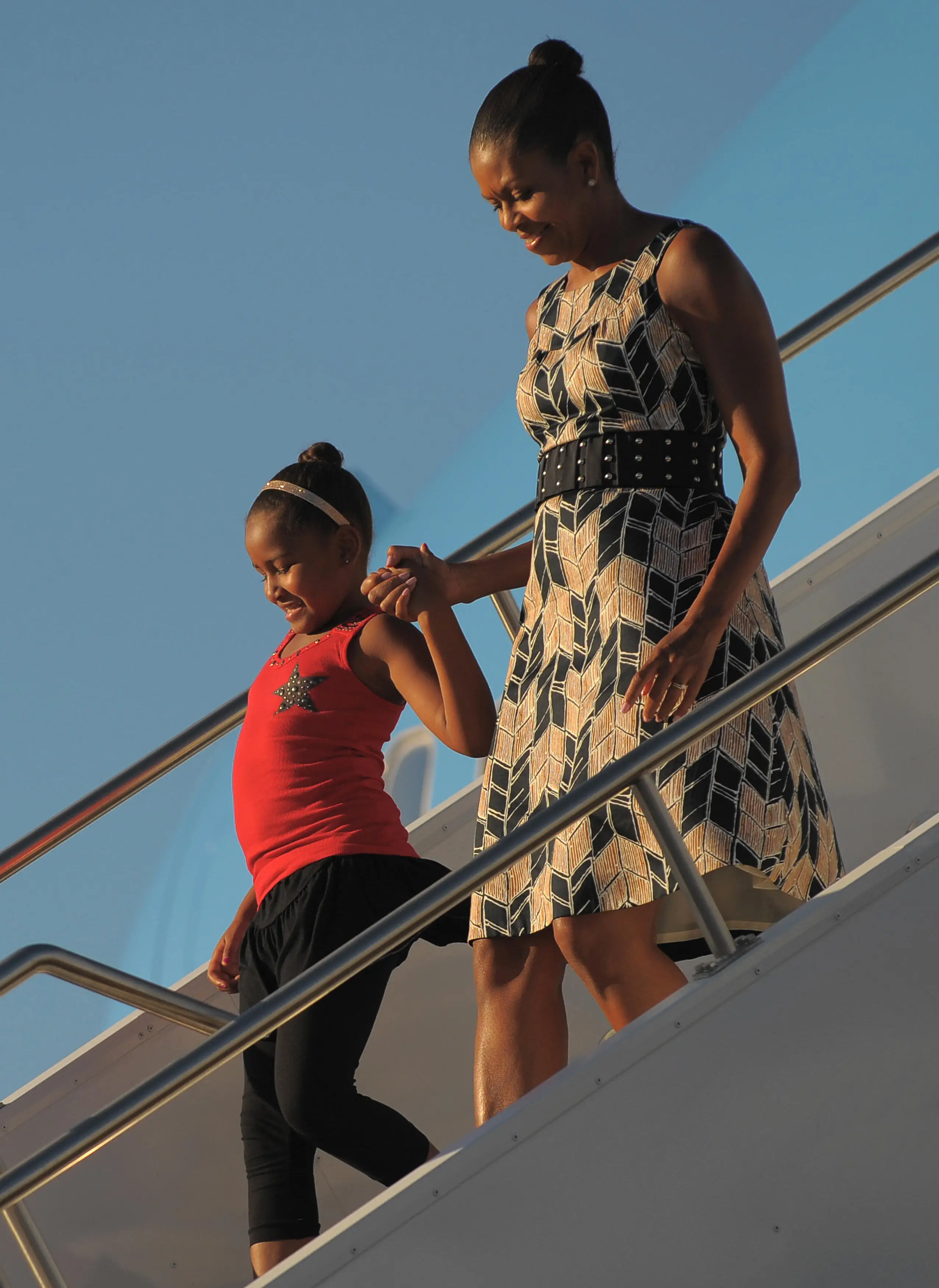 First Lady Michelle Obama and daughter Sasha step off Air Force One August 15, 2009 upon arrival at Sky Harbor Airport in Phoenix, Arizona. AFP PHOTO/Mandel NGAN