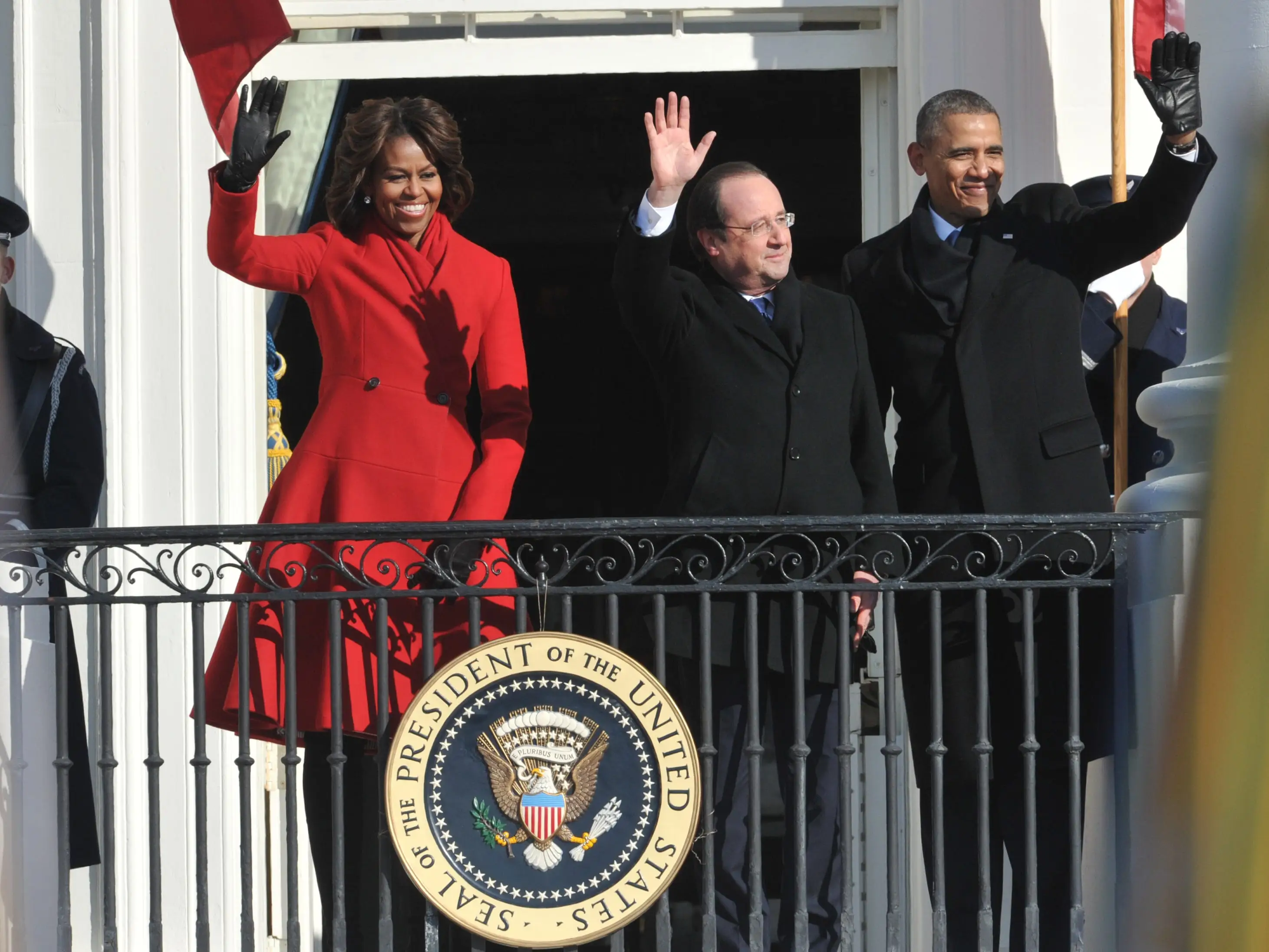 US President Barack Obama and First Lady Michelle Obama wave to the crowd with French President Francois Hollande (C) during a greeting ceremony on the South Lawn of the White House in Washington, DC, on February 11, 2014.