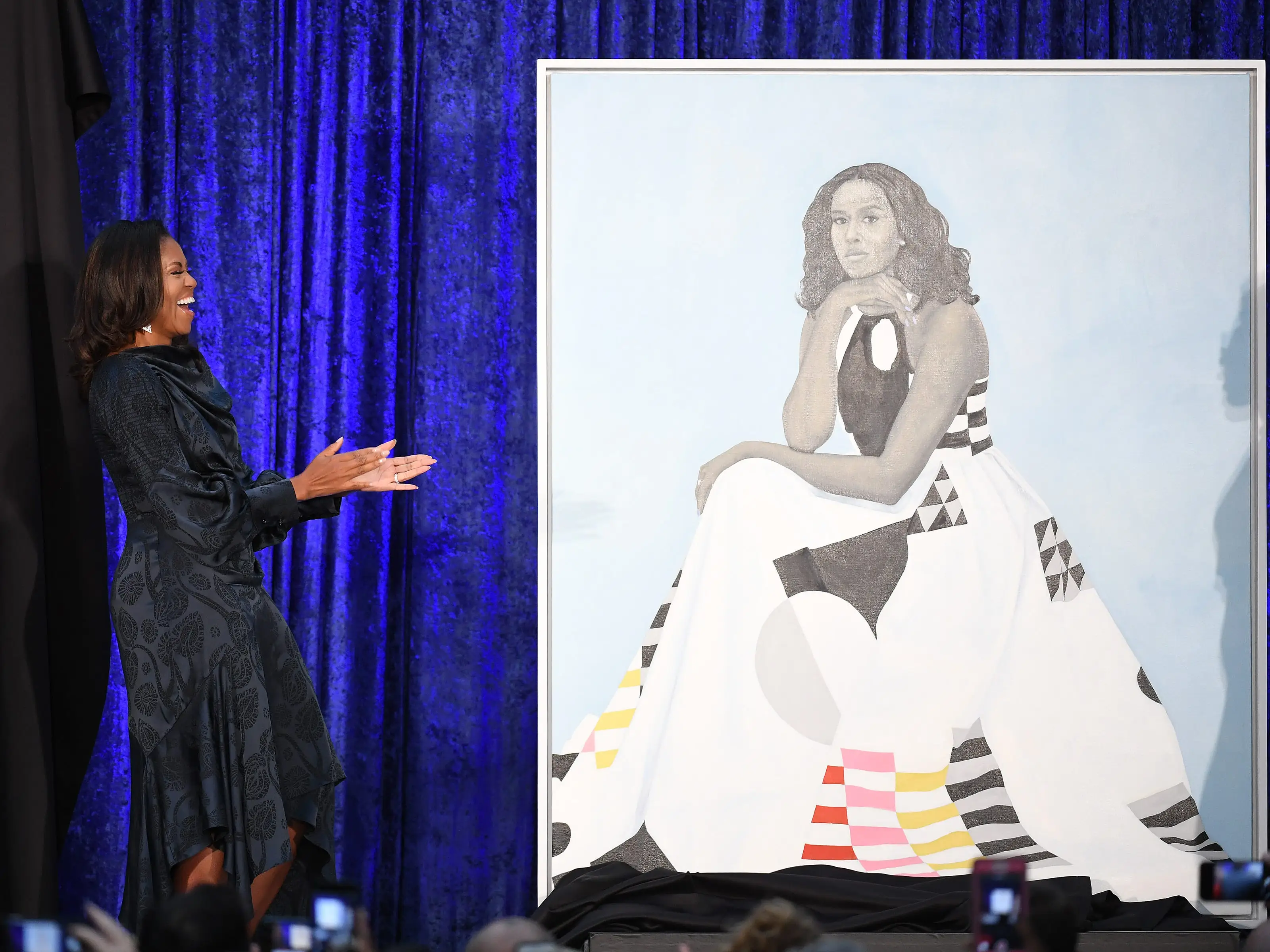 Former First Lady Michelle Obama stands next to her portrait as she and former President Barack Obama have their portraits unveiled at the Smithsonian National Portrait Gallery on Monday February 12, 2018 in Washington, DC.
