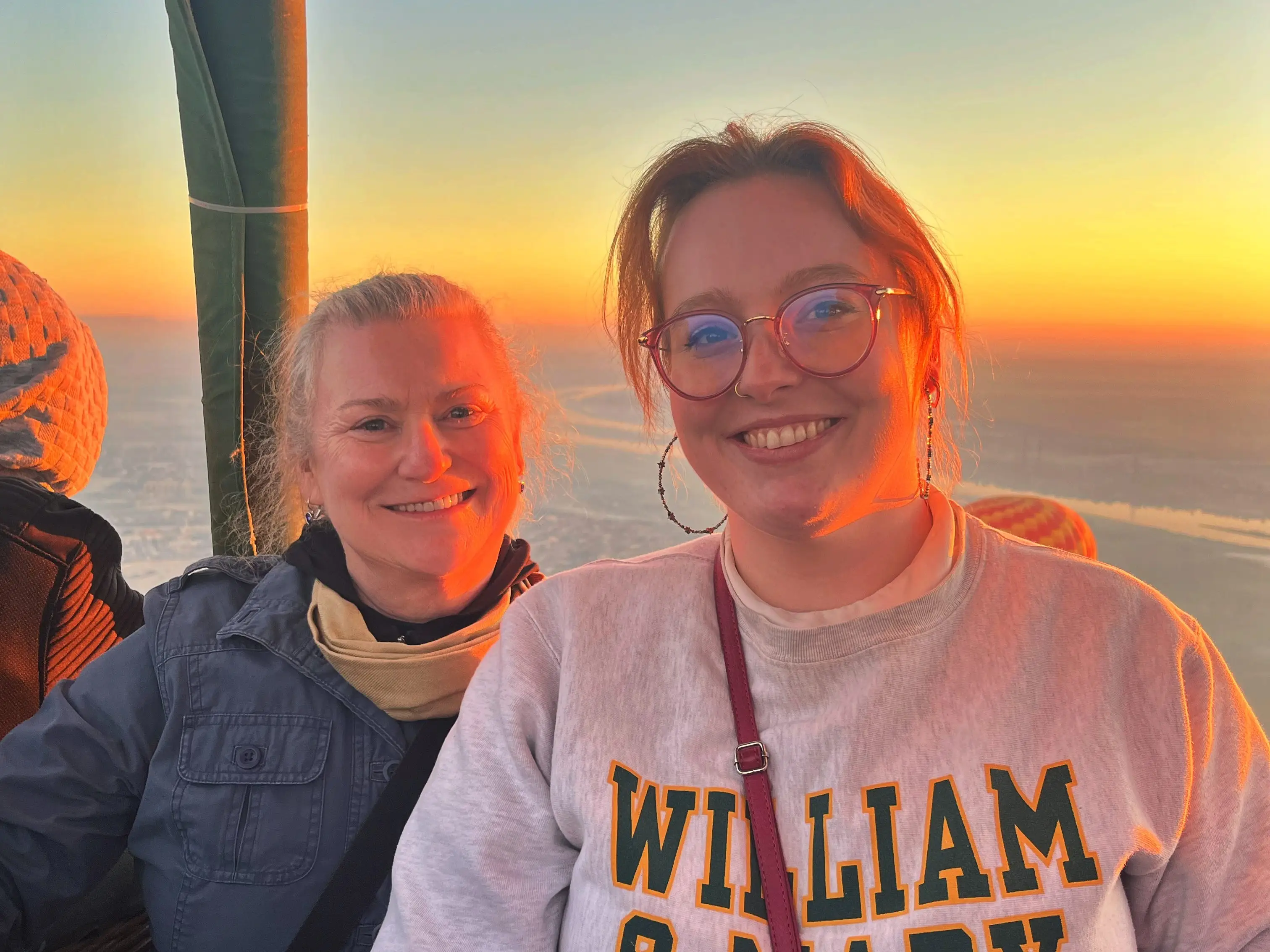 The writer and her mom are sitting in a hot-air balloon basket.