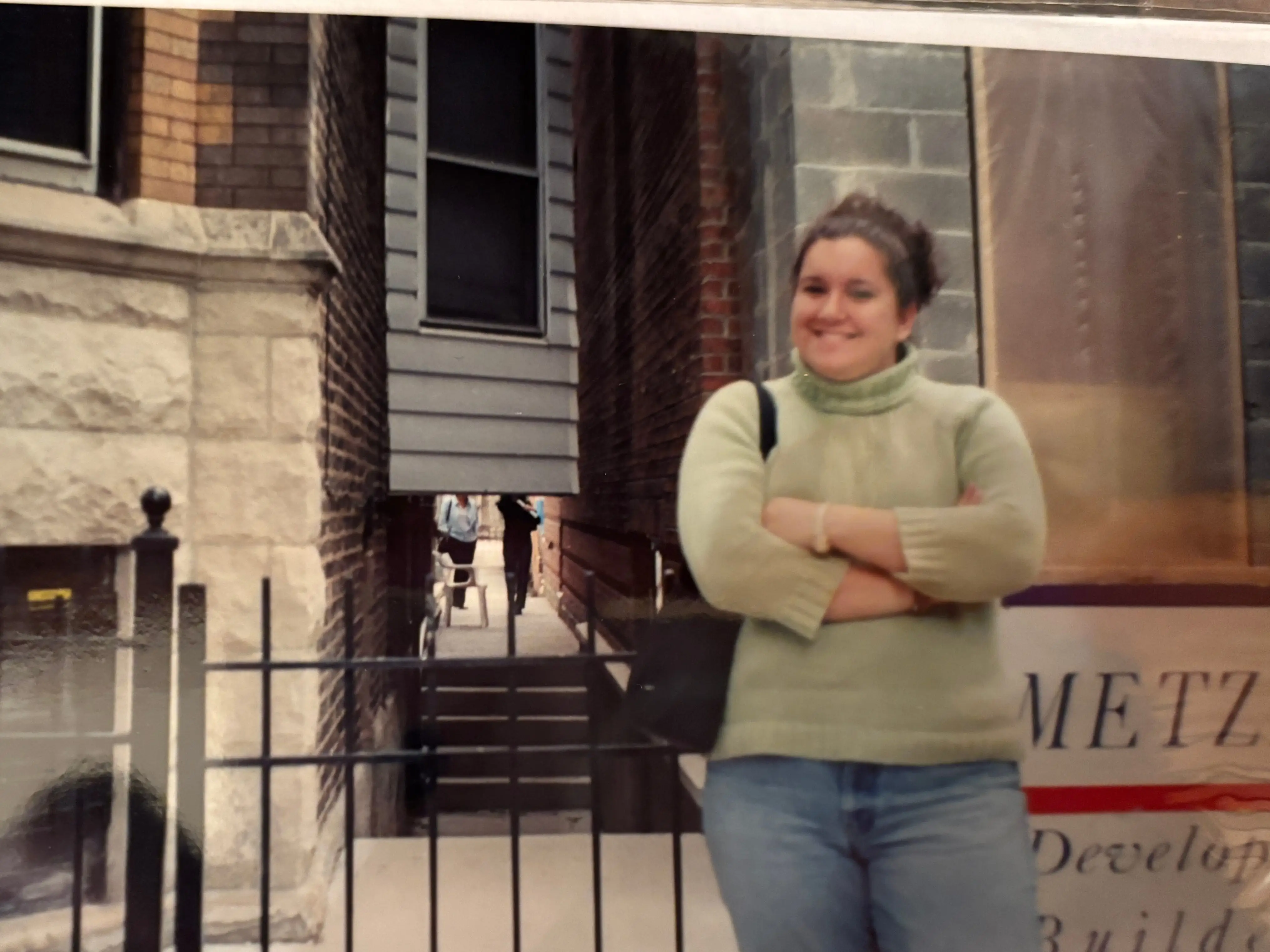 The author standing outside of her first apartment after graduating from college.