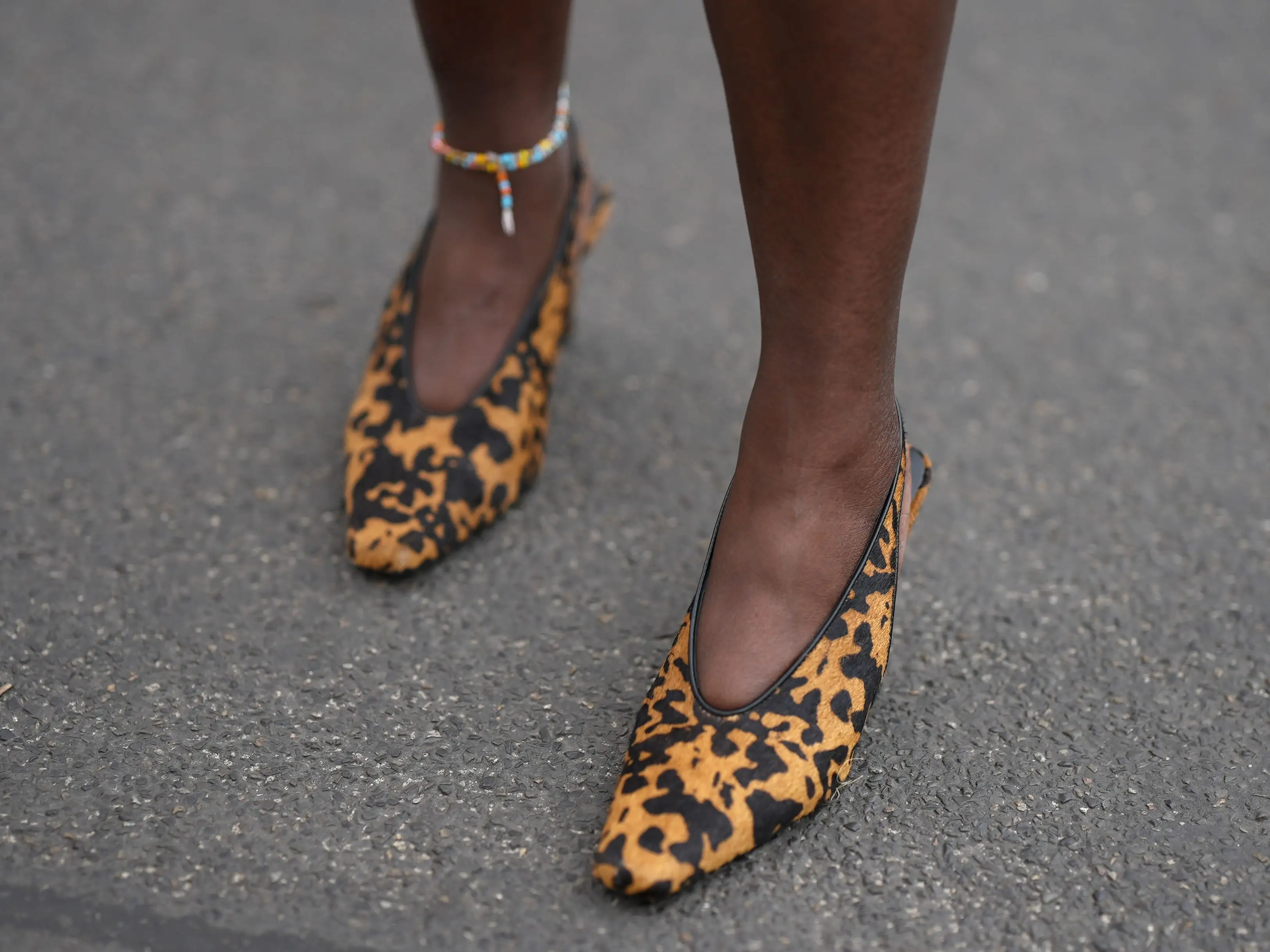 A woman wearing a pair of short leopard-print heels.