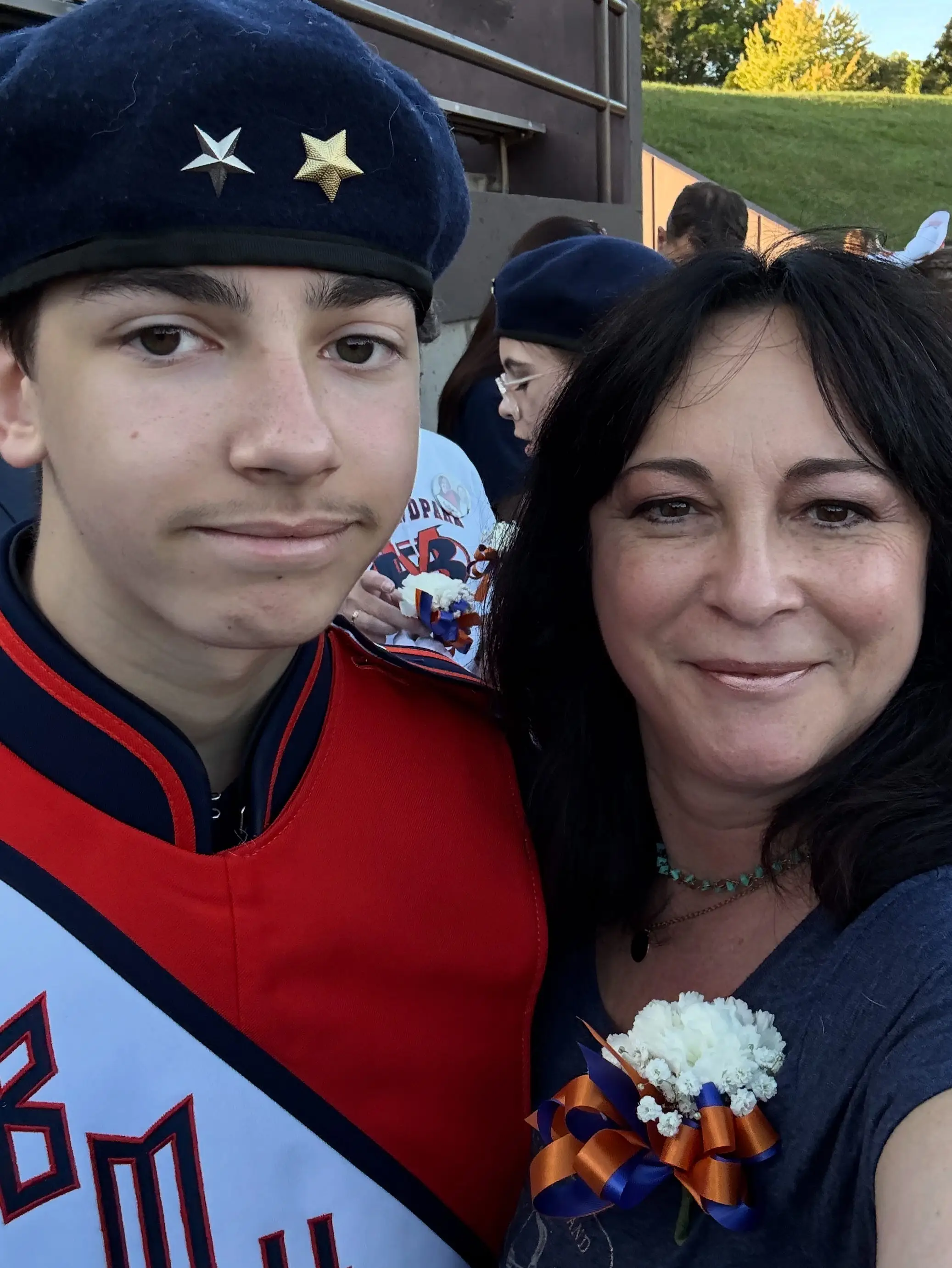 The author and her son pose after he performs with the marching band.
