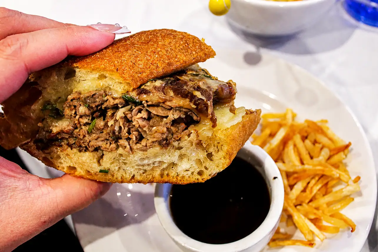author holding the salt hanks french dip sandwich