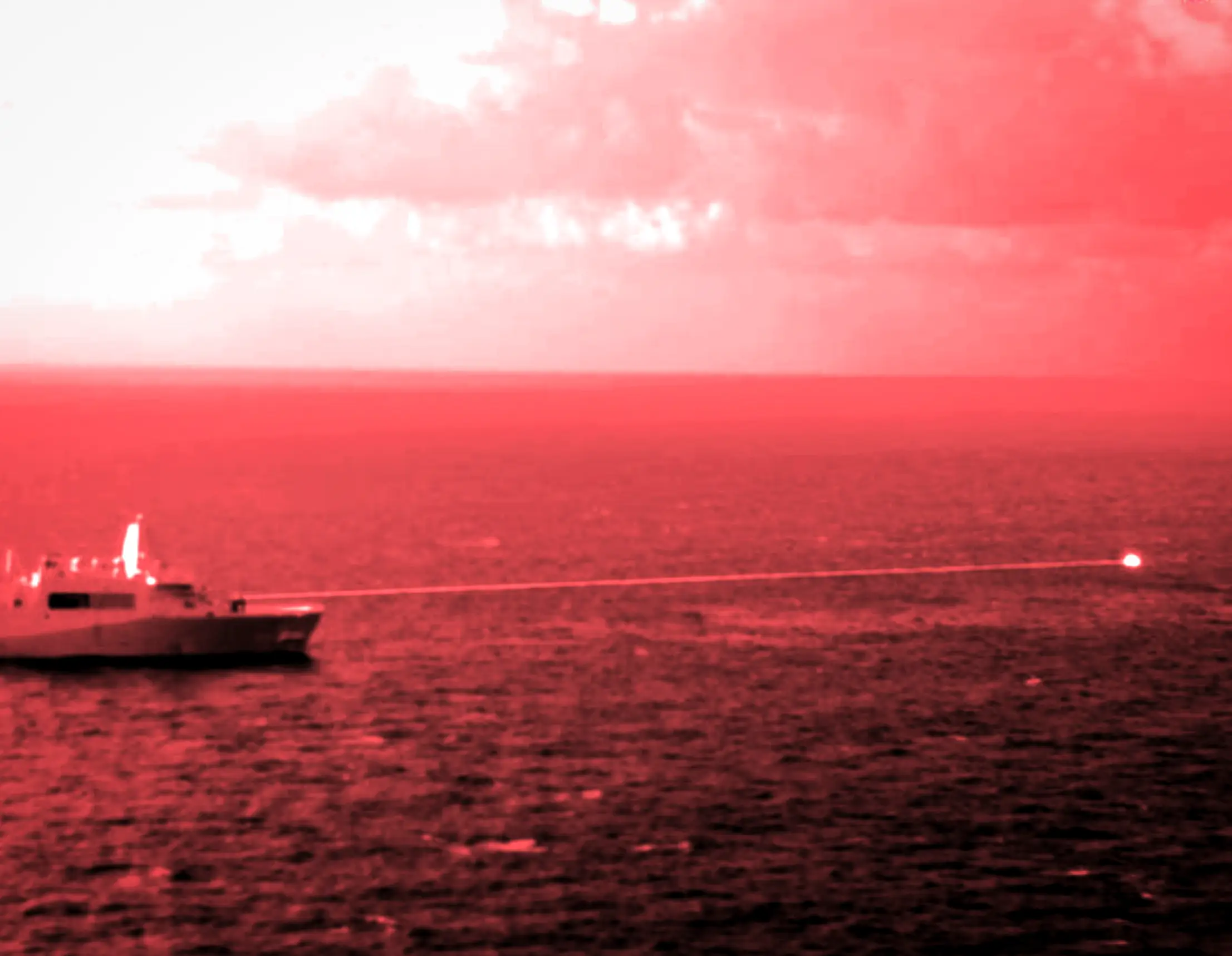 The USS Portland fires a laser weapon in a test in the Gulf of Aden.