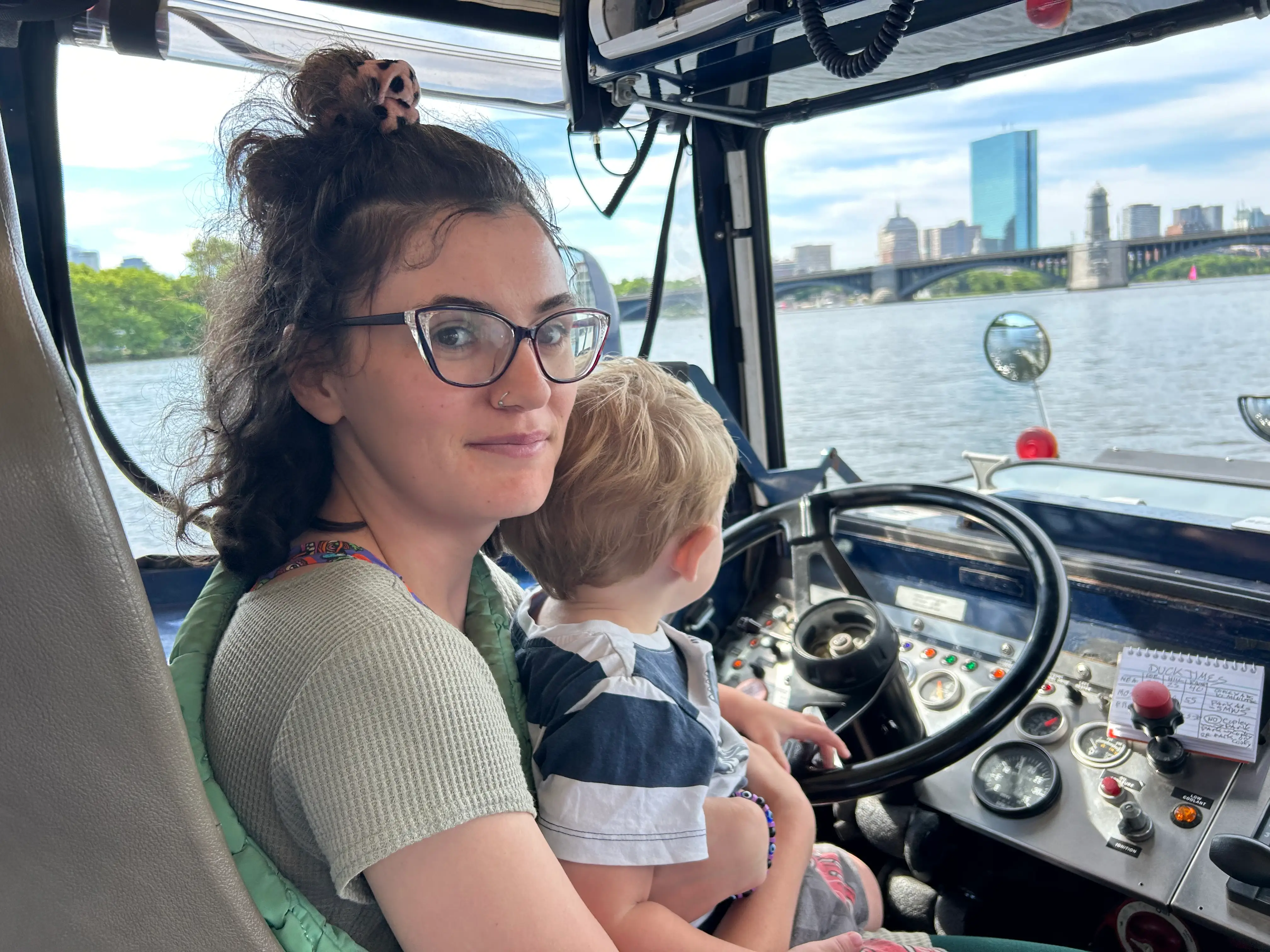 woman smiling with kid on her lap on a boat