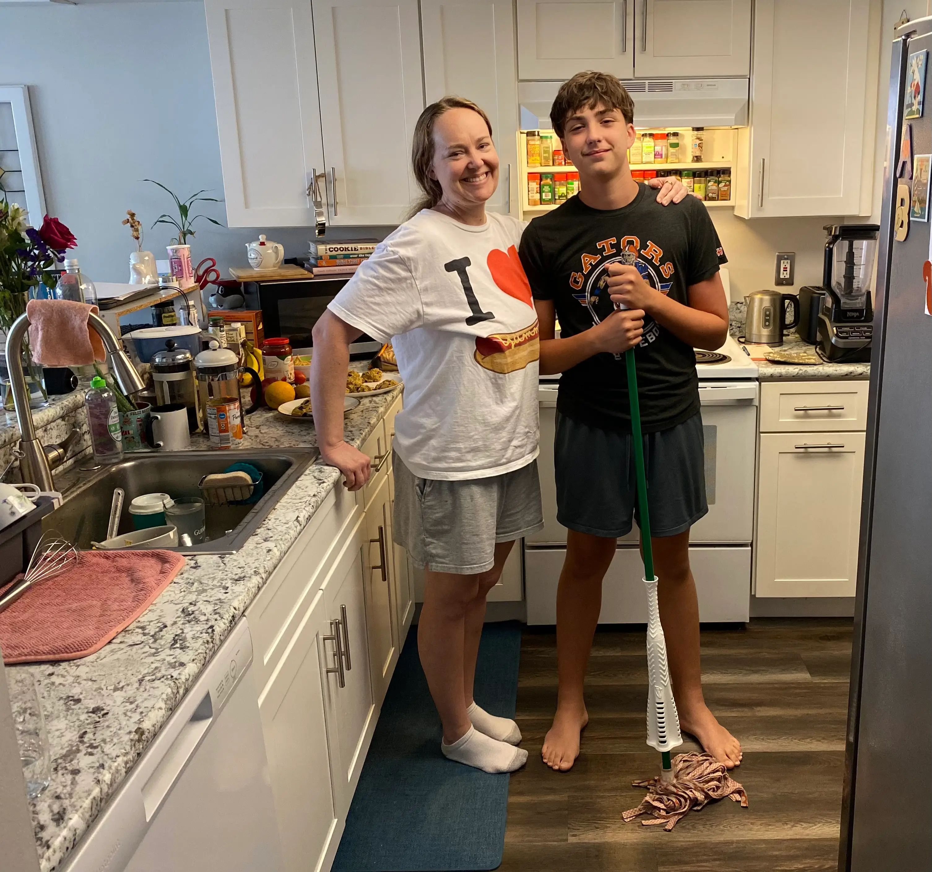 the author and her son in their kitchen while cleaning.