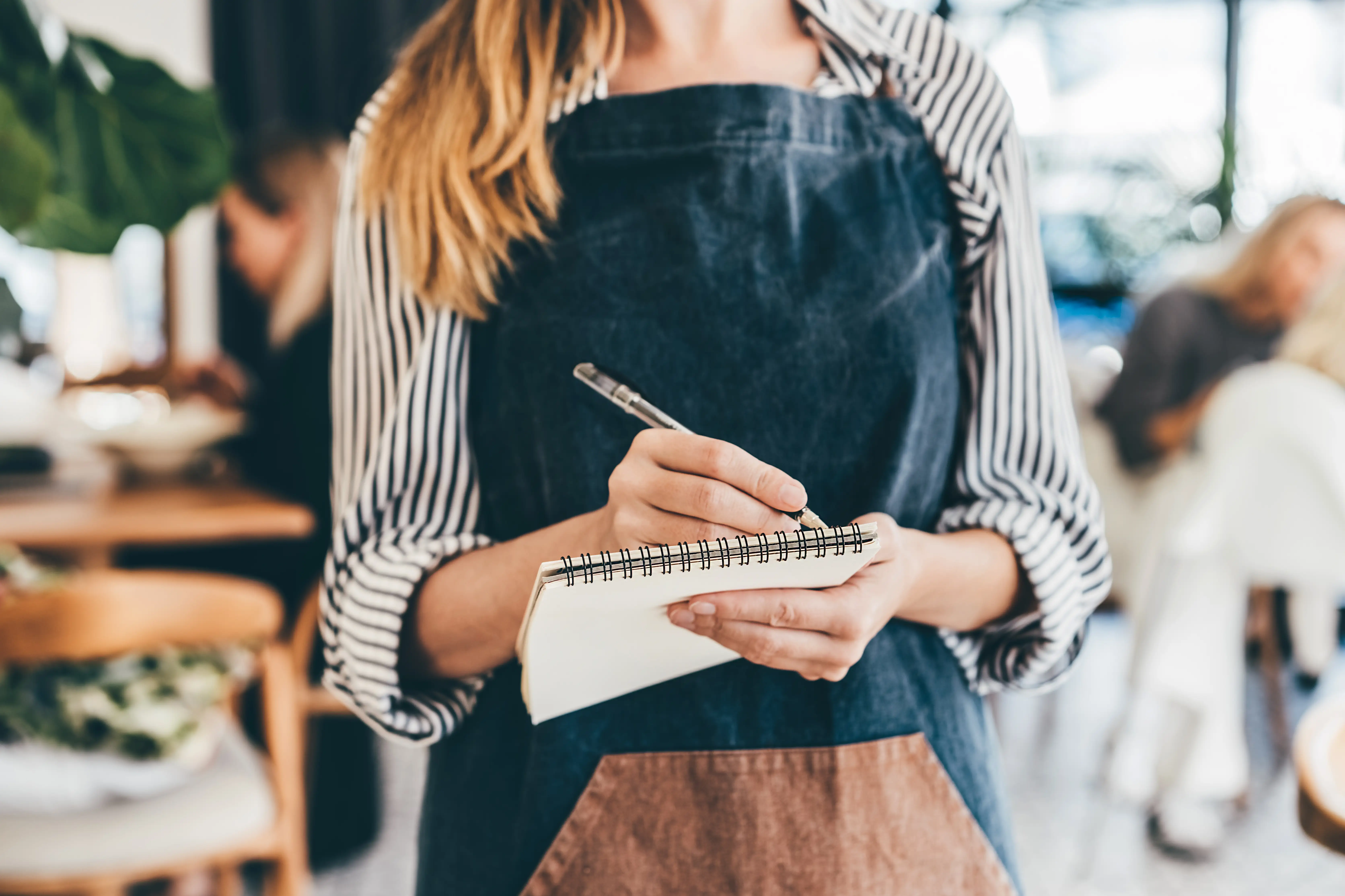 A waitress taking an order at a restaurant.
