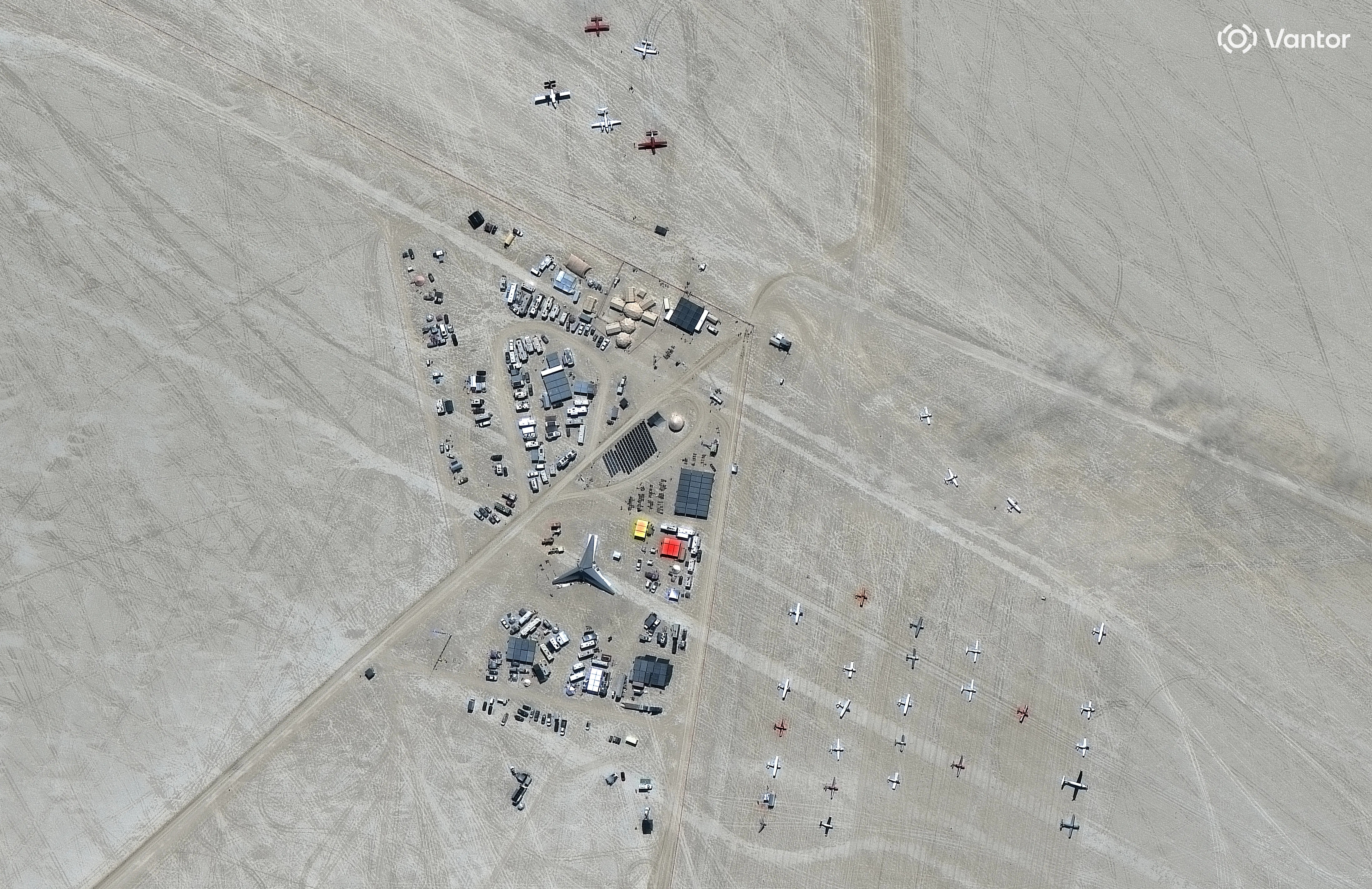 Vantor satellite image shows a temporary airport with numerous small planes and support vehicles set up in the Black Rock Desert during the Burning Man event. Please use: Satellite image (c) 2026 Vantor.