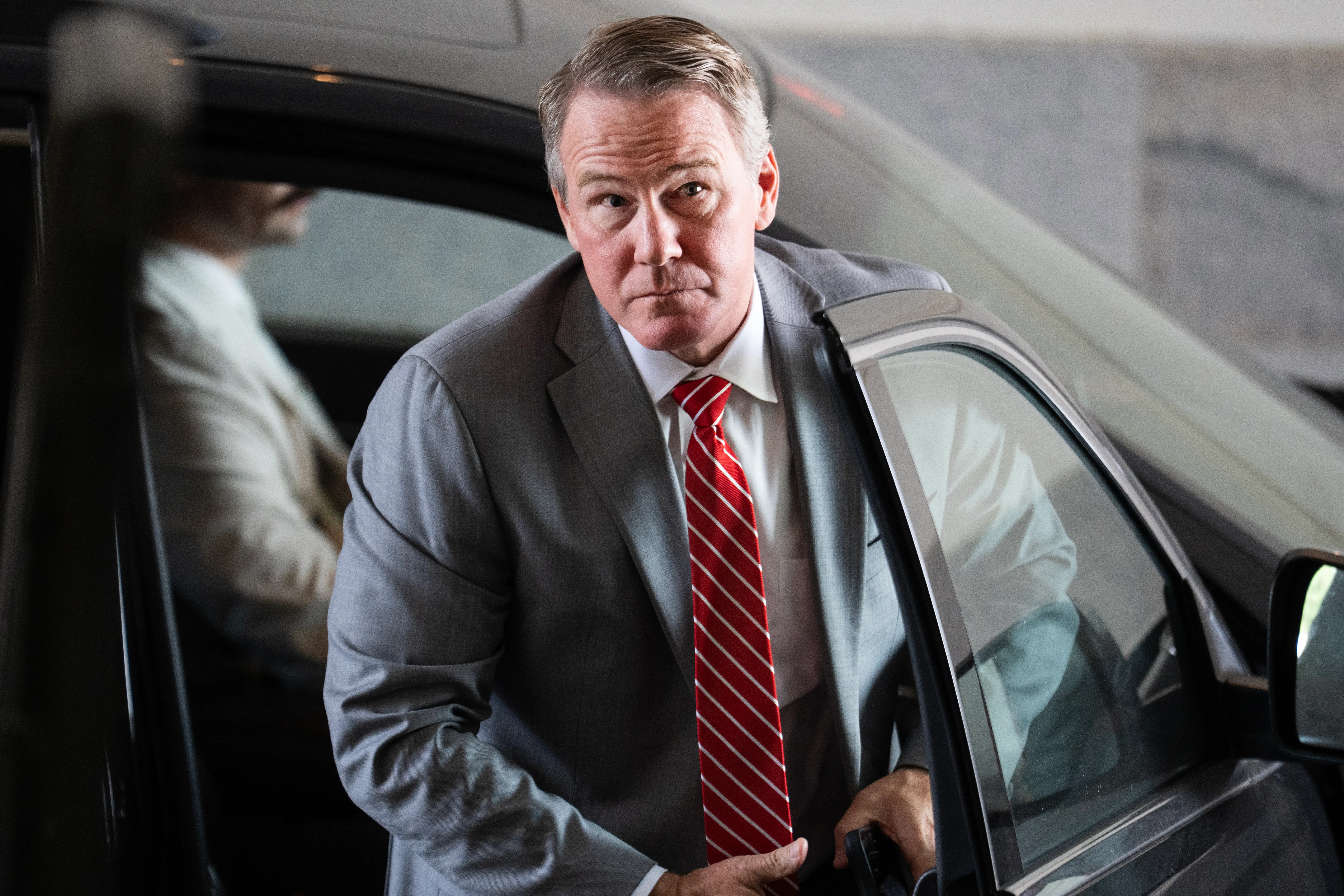 Ohio Sen. Jon Husted emerges from a car