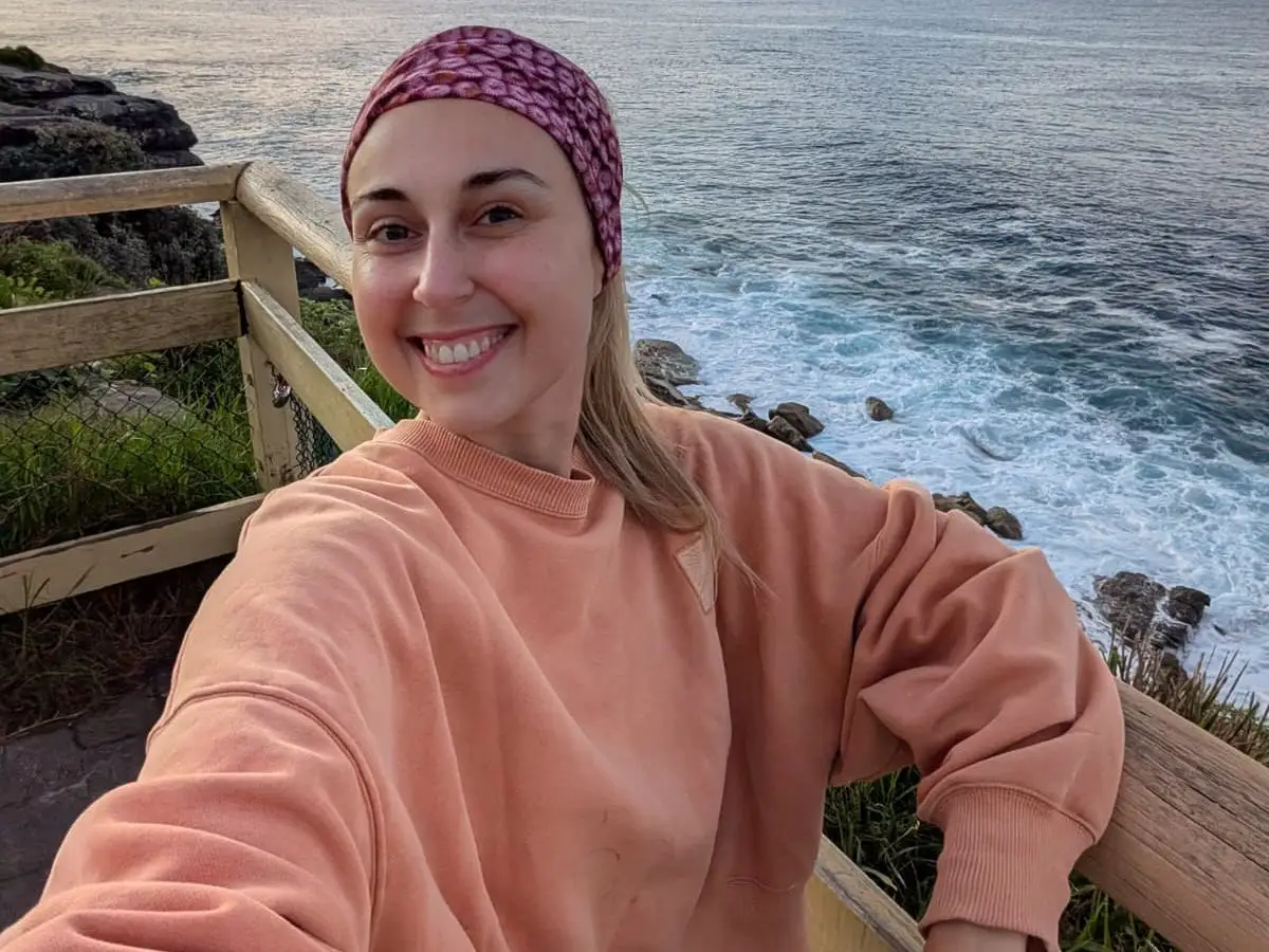 Woman taking selfie by the water