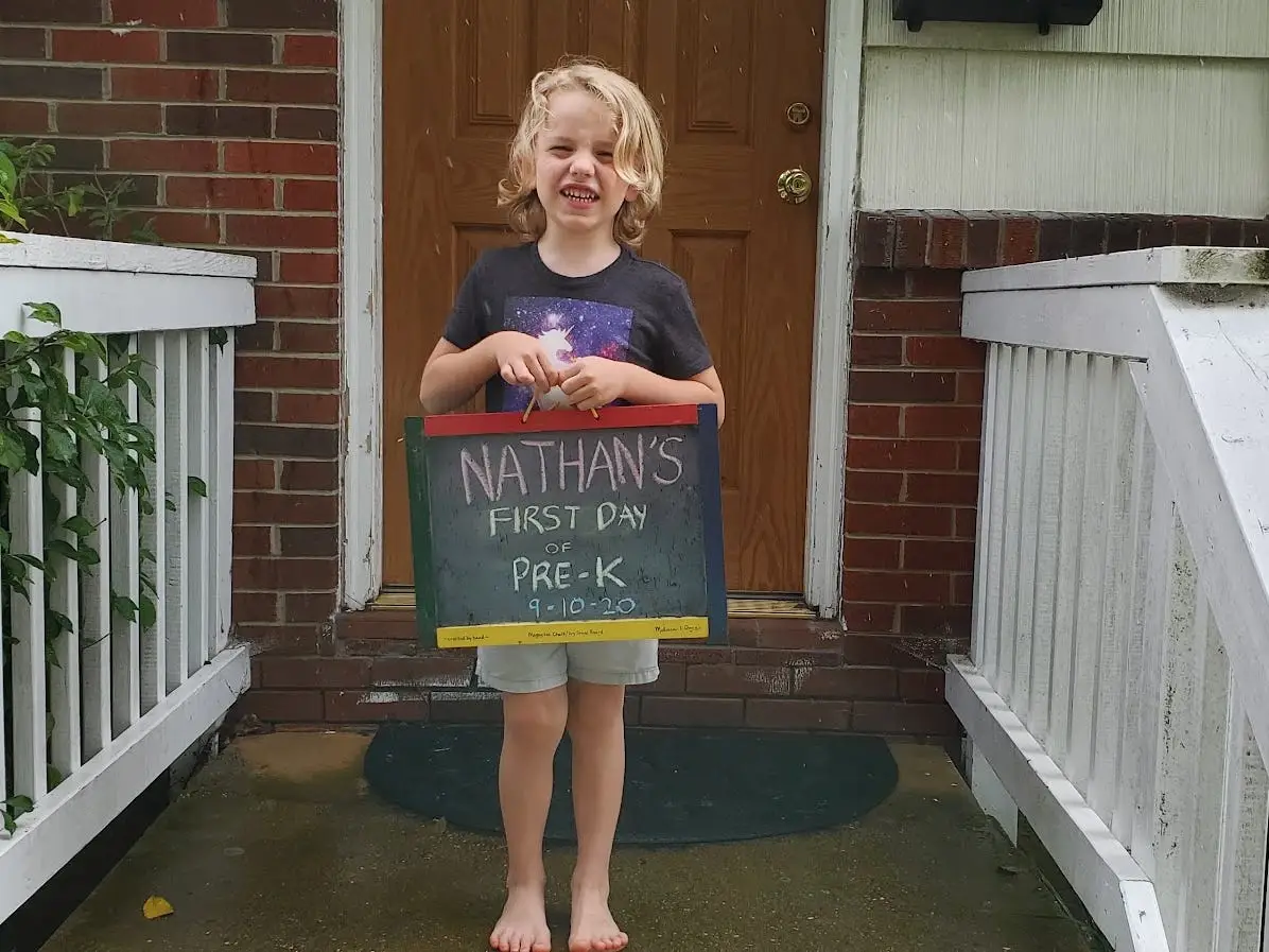 Boy posing with Pre-K sign