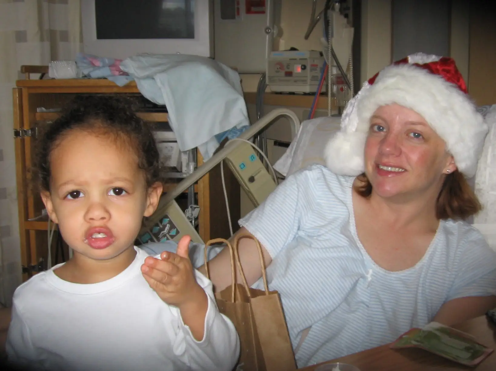 the author in bed at a hospital with her daughter looking at the camera
