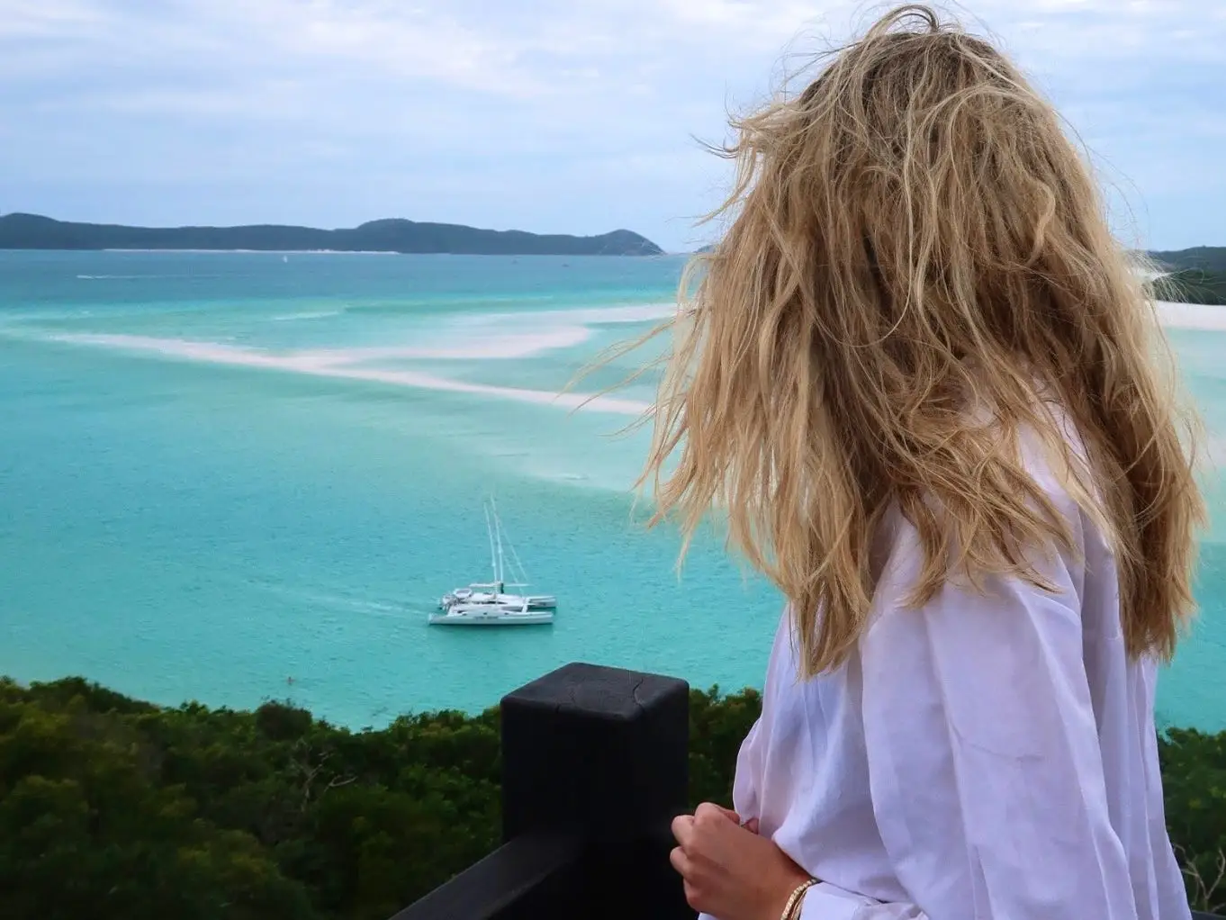 Woman looking at turquoise blue waters