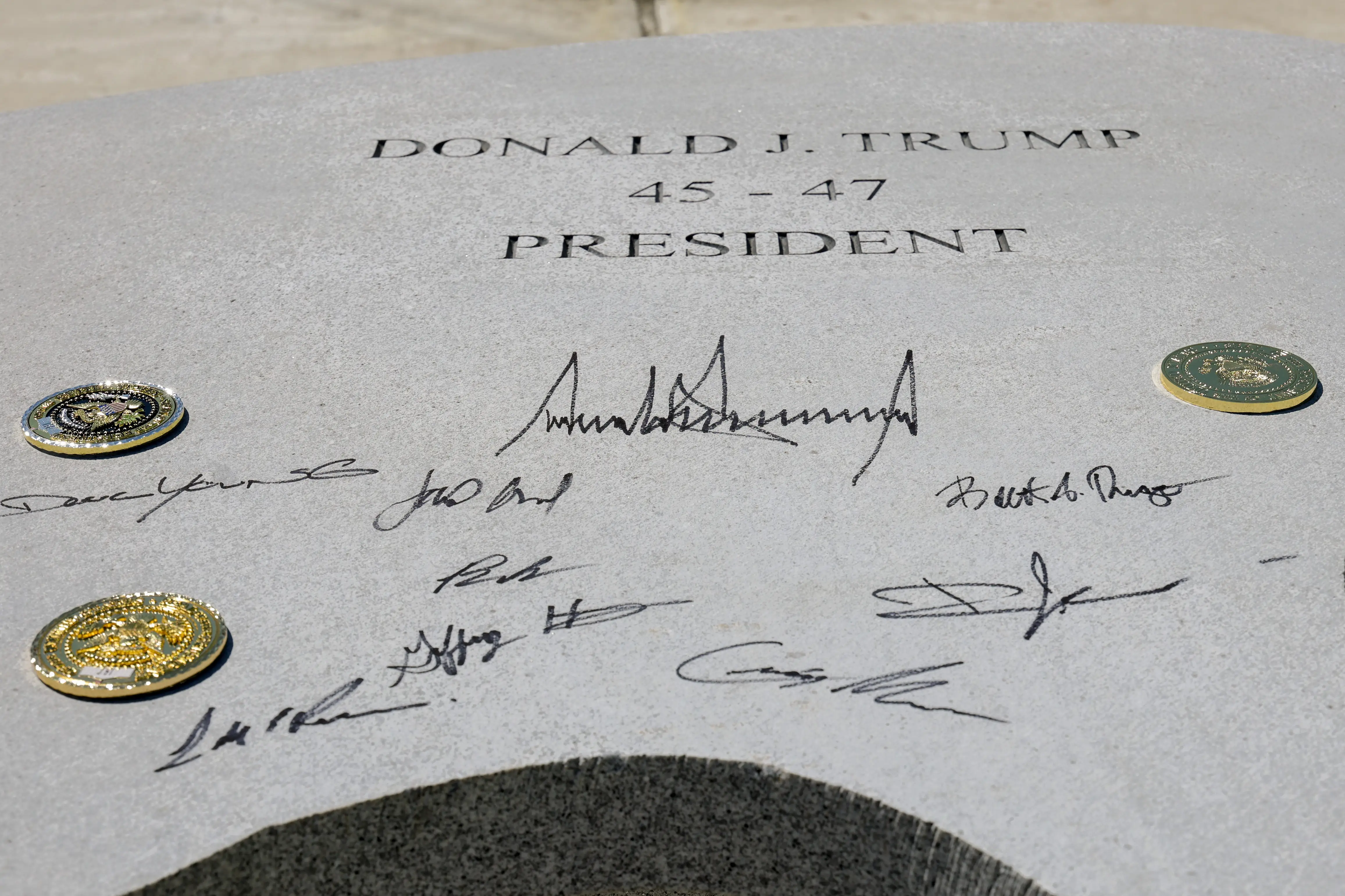 Trump's signature on granite slab.