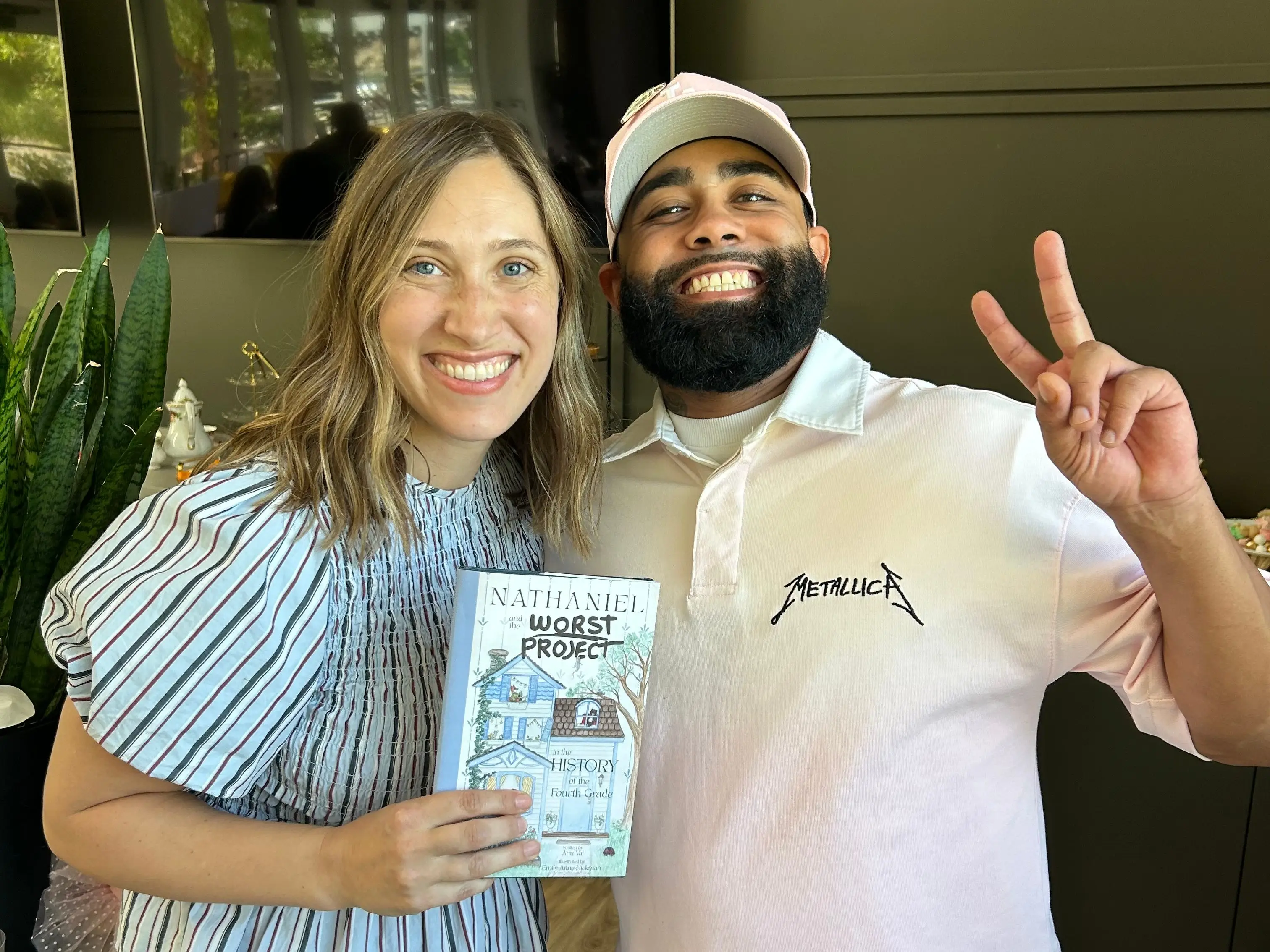 the author holding her book and standing next to her brother