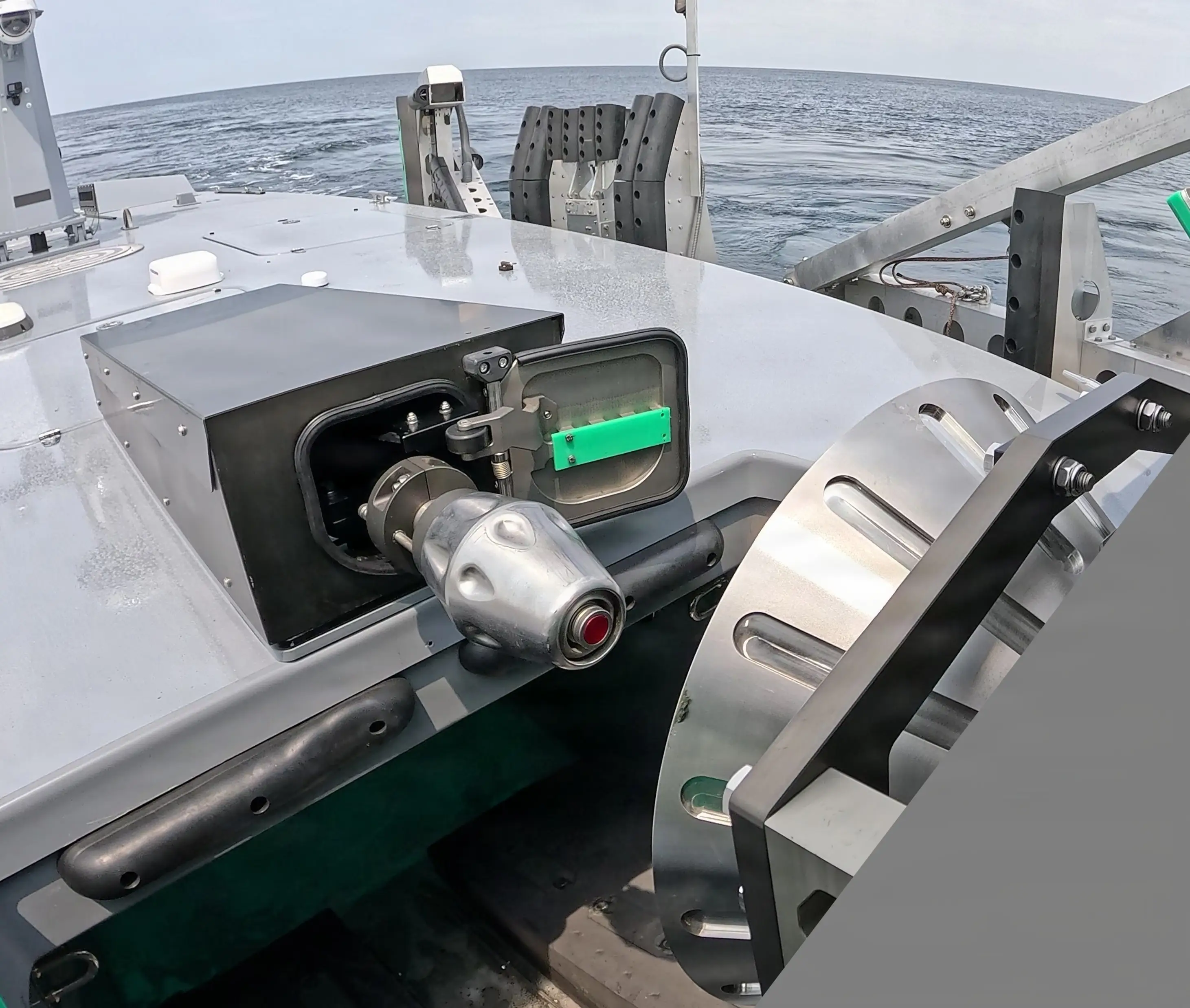 A refueling probe on a naval drone approaches a towable capture and connection refueling device.
