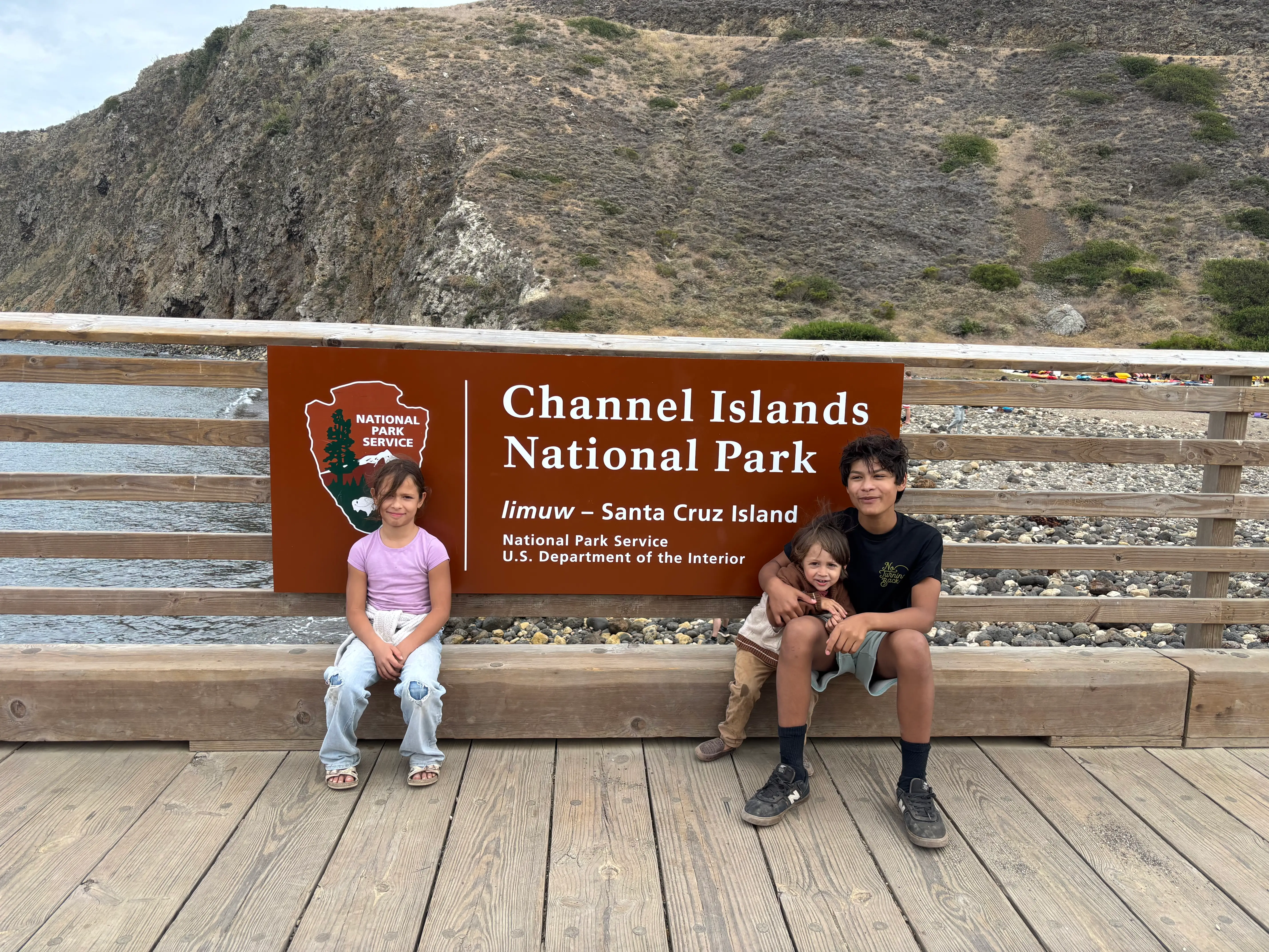 the author's kids in front of a sign that says