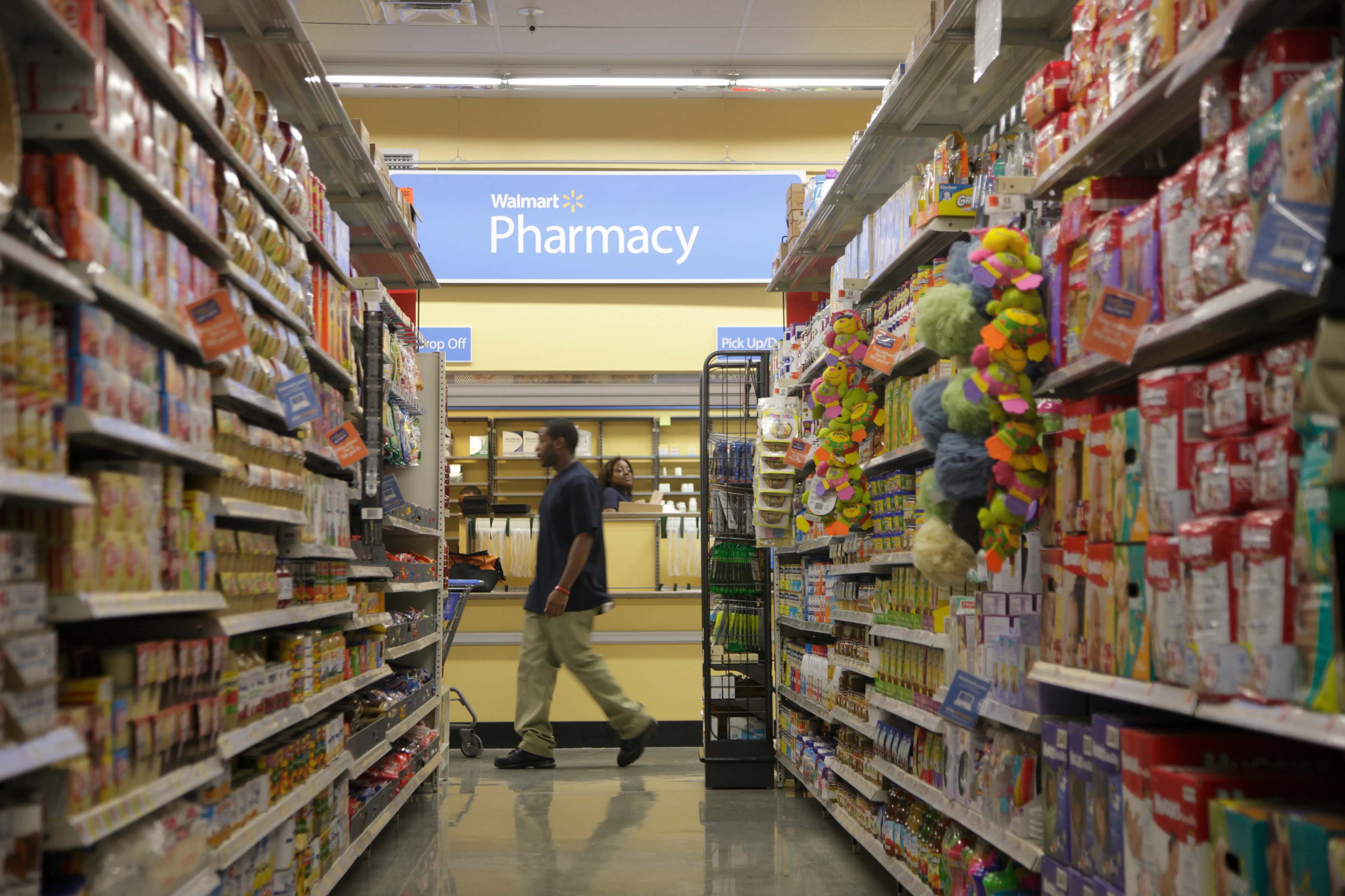 A worker walks past the Pharmacy in a new Walmart Express store in Chicago, July 26, 2011.