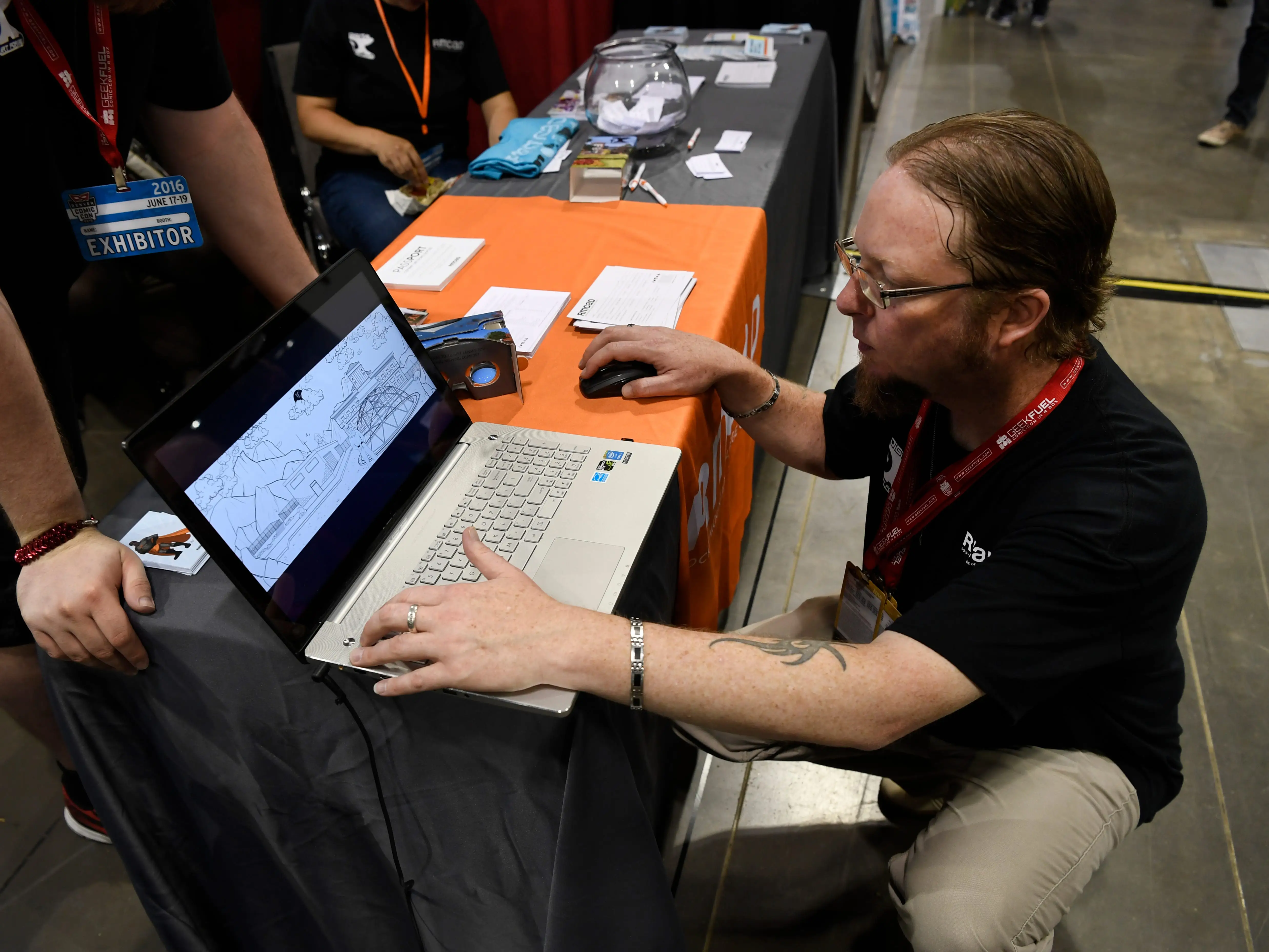 Sean Brown, Rocky Mountain College of Art and Design instructor looks at conceptual drawings for a virtual reality comic book at the Colorado Convention Center June 16, 2016. (