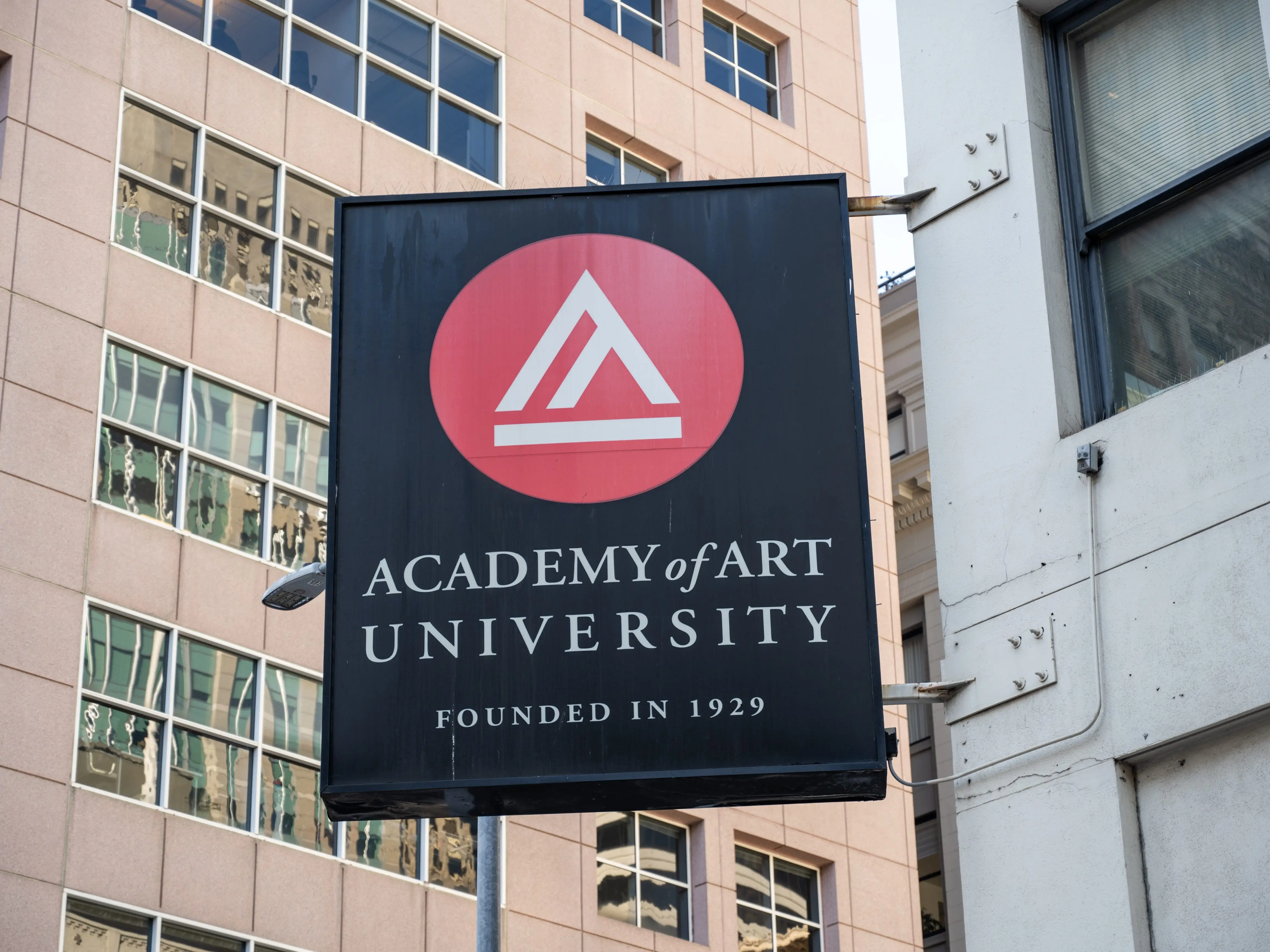 Academy of Art University sign on urban street with surrounding office buildings, San Francisco, California, December 4, 2025.