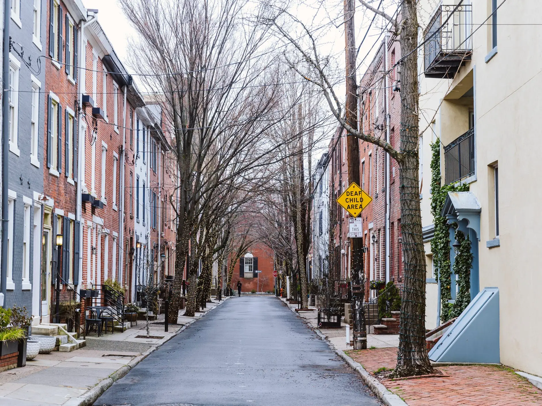 Rows of brownstone apartment buildings in Center City with windows, stoops and plants in Philadelphia