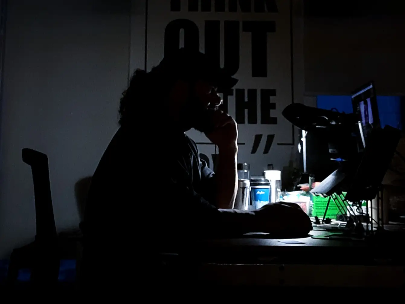 A man taking work calls int he middle of the night.