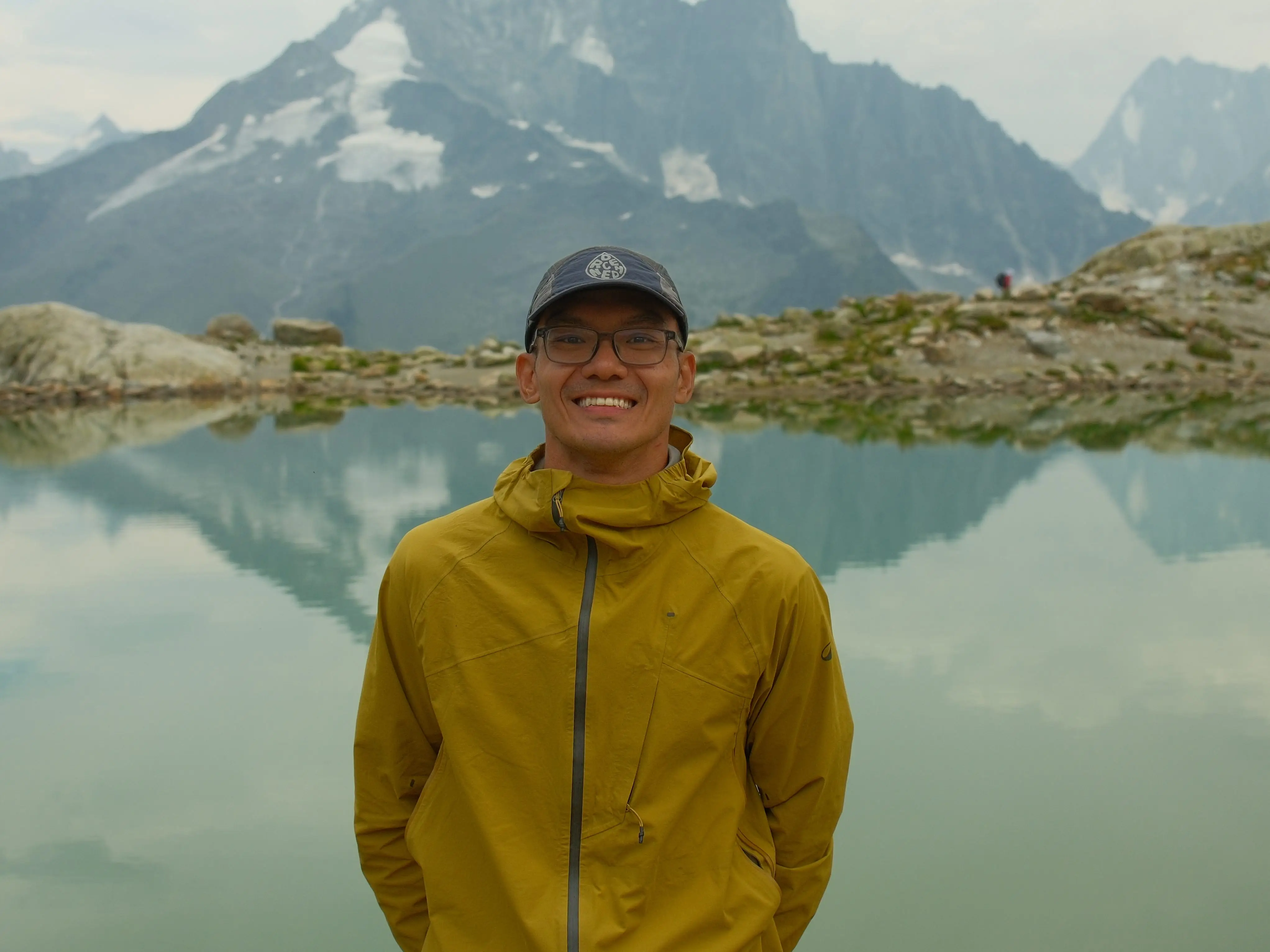 A man posiing for a photo on a hike.