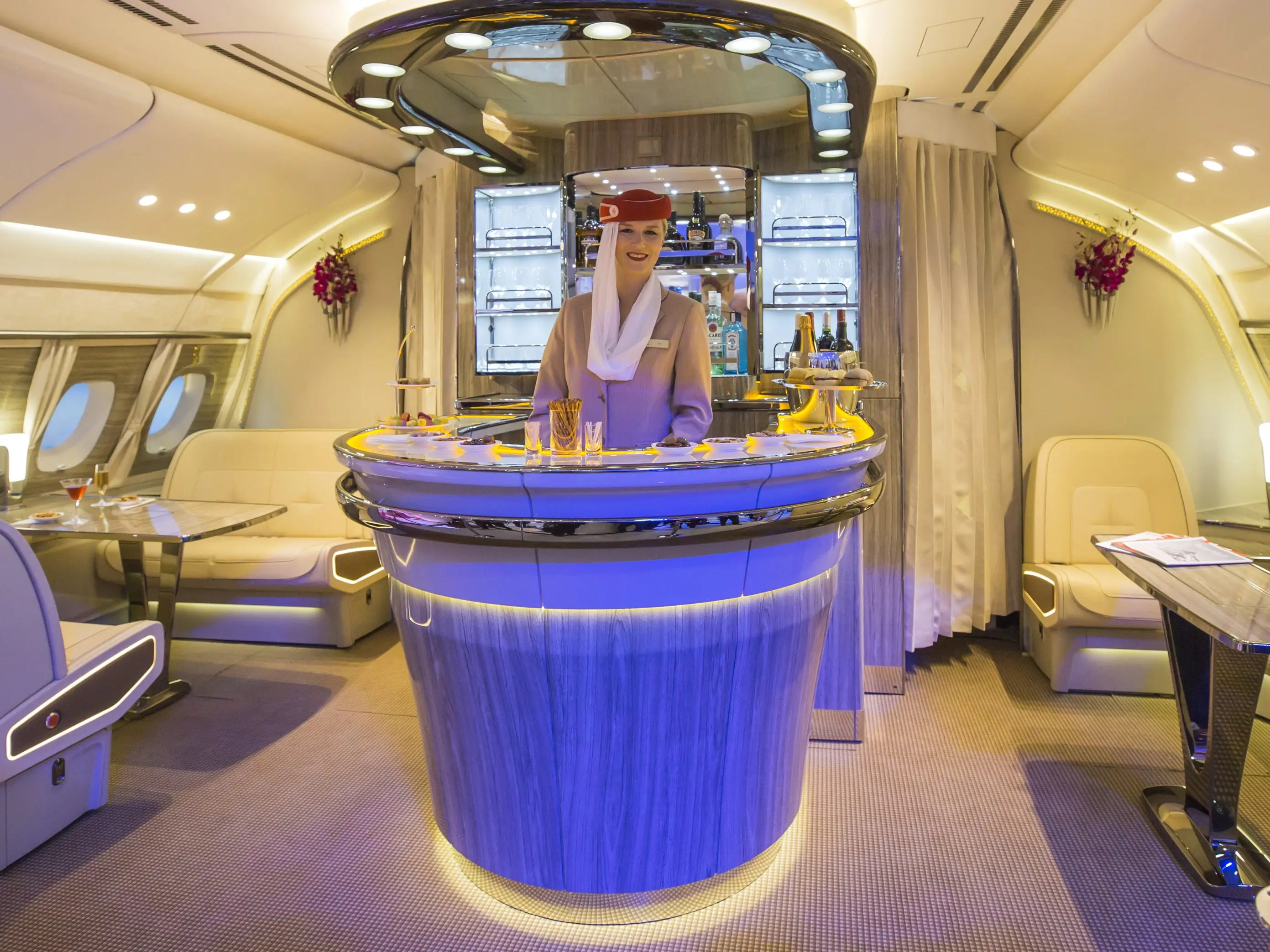 An Emirates Airlines cabin crew attendant stands in the new bar area for the Airbus A380 aircraft during the unveiling at the ITB Travel Fair in Berlin, Germany, on Wednesday, March 8, 2017.