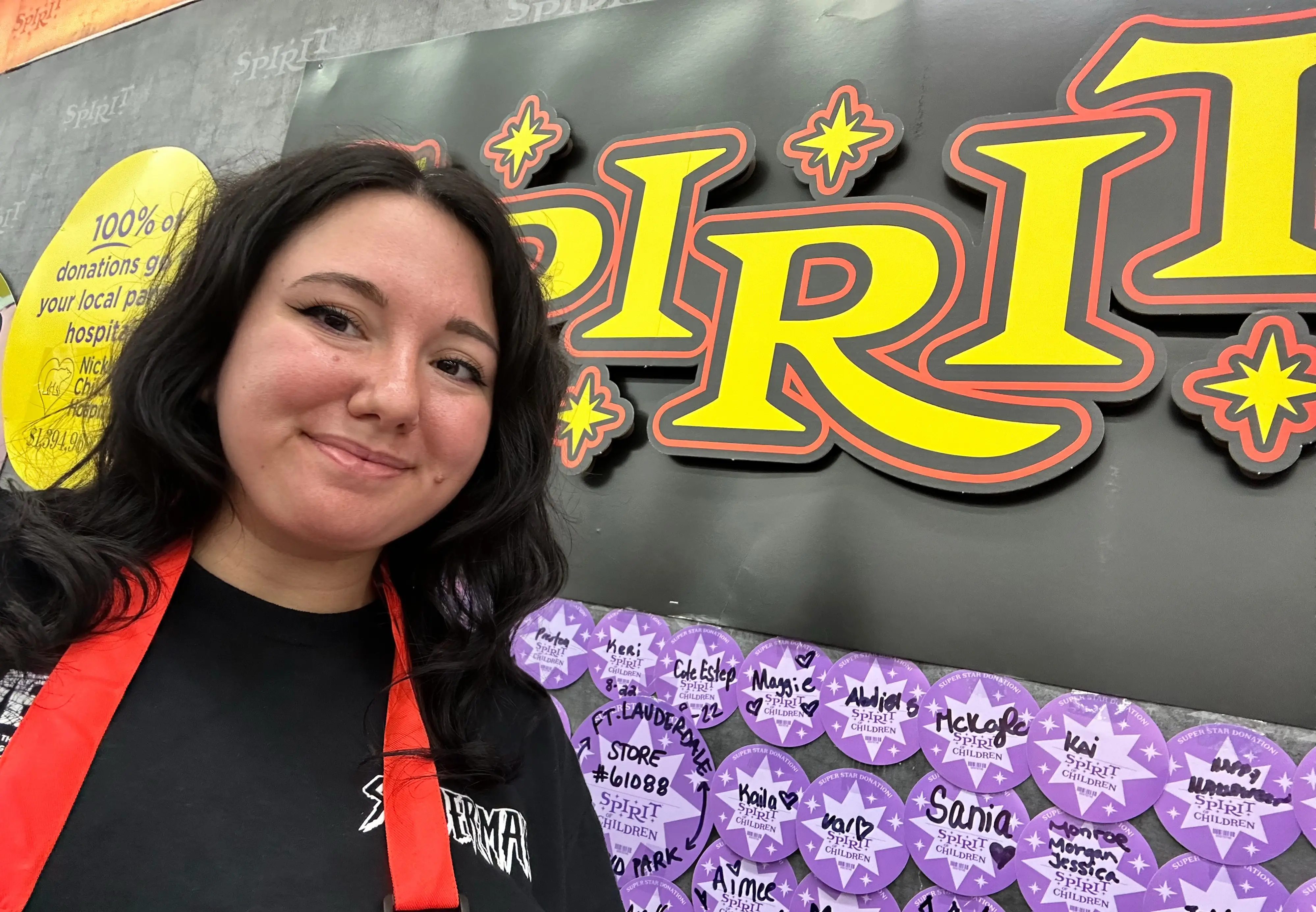 Maggie Bodner in front of Spirit Halloween sign