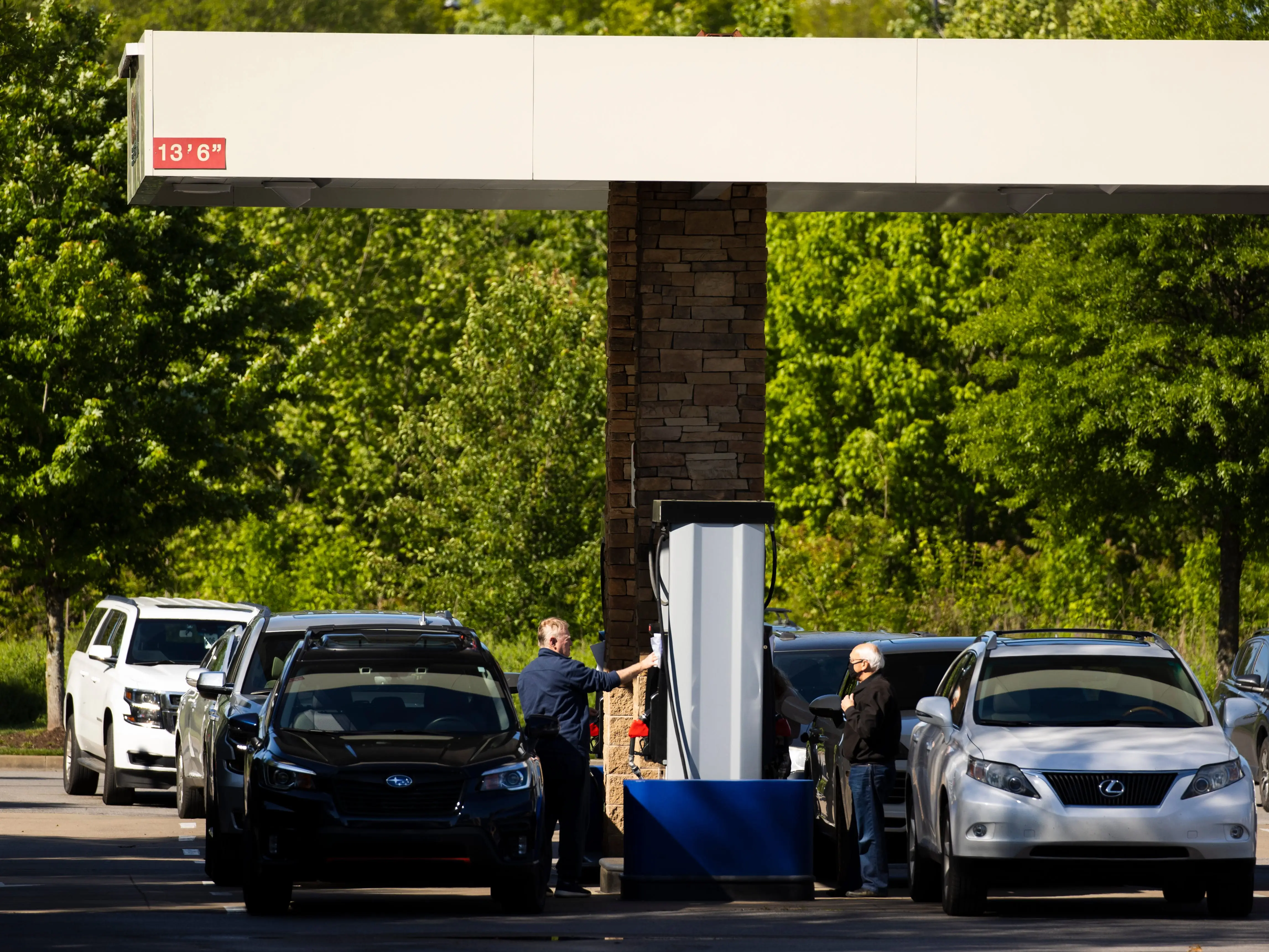 Customers fill their vehicles with gas at a Costco gas station in Tennessee.