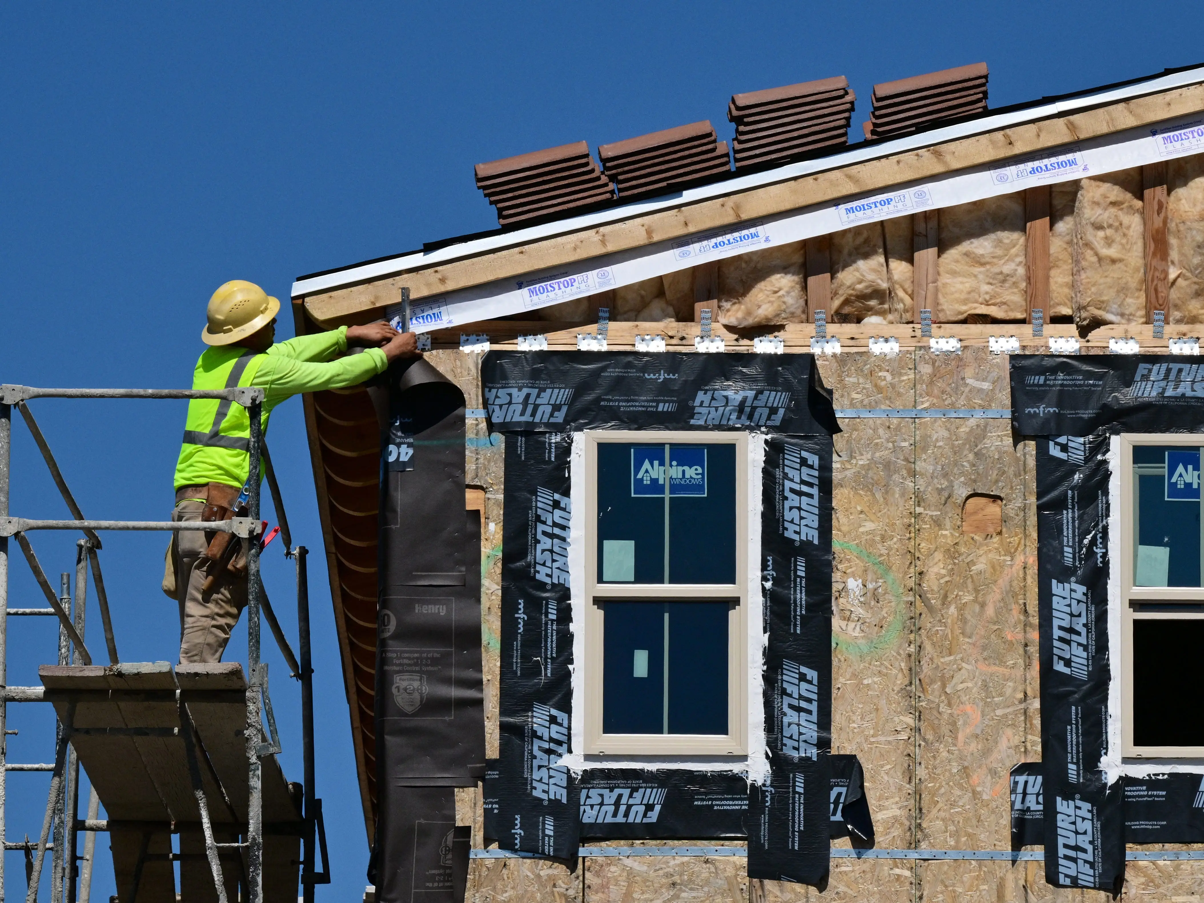 A construction worker is working on a home