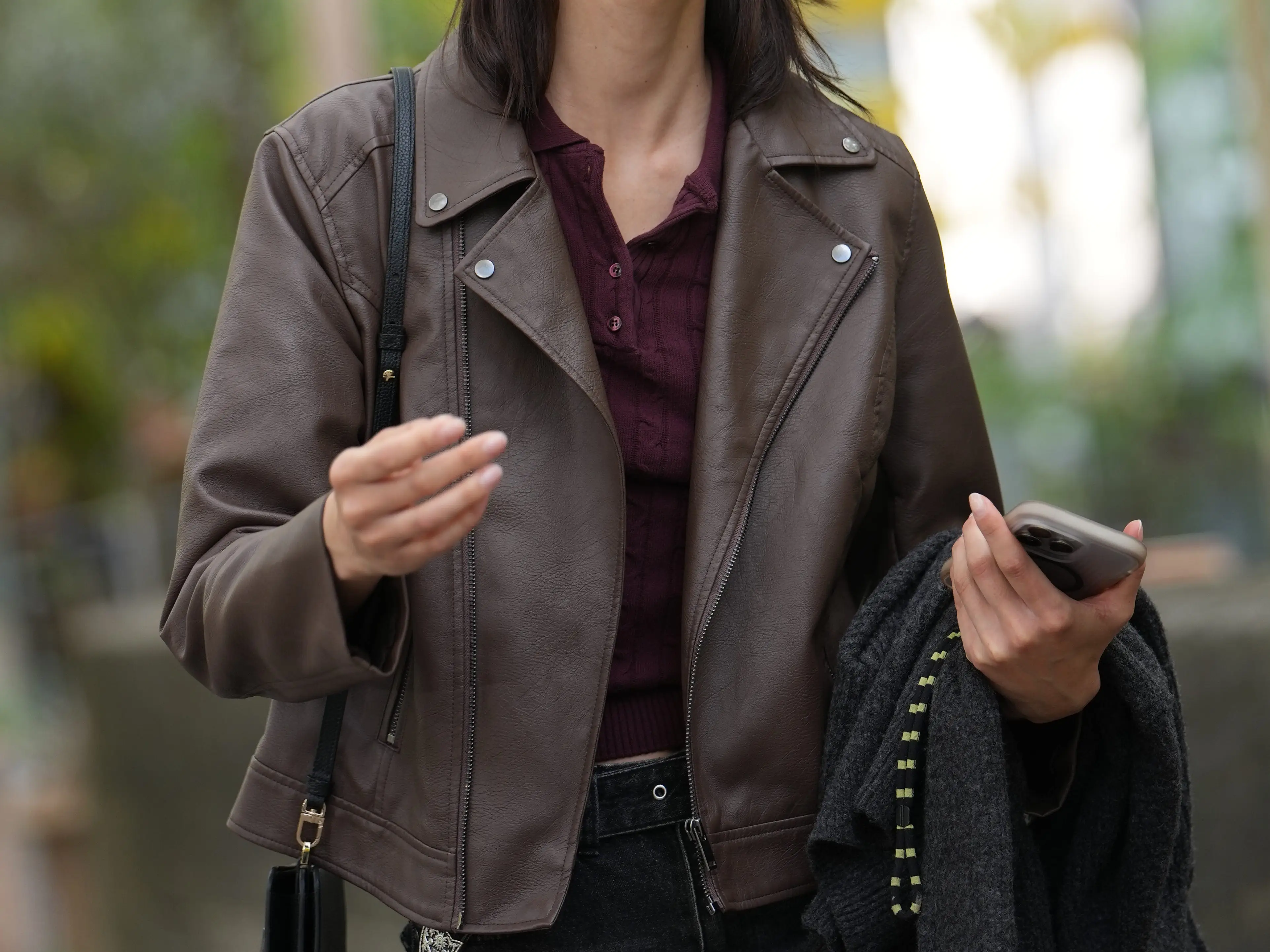 Woman wearing brown moto leather jacket