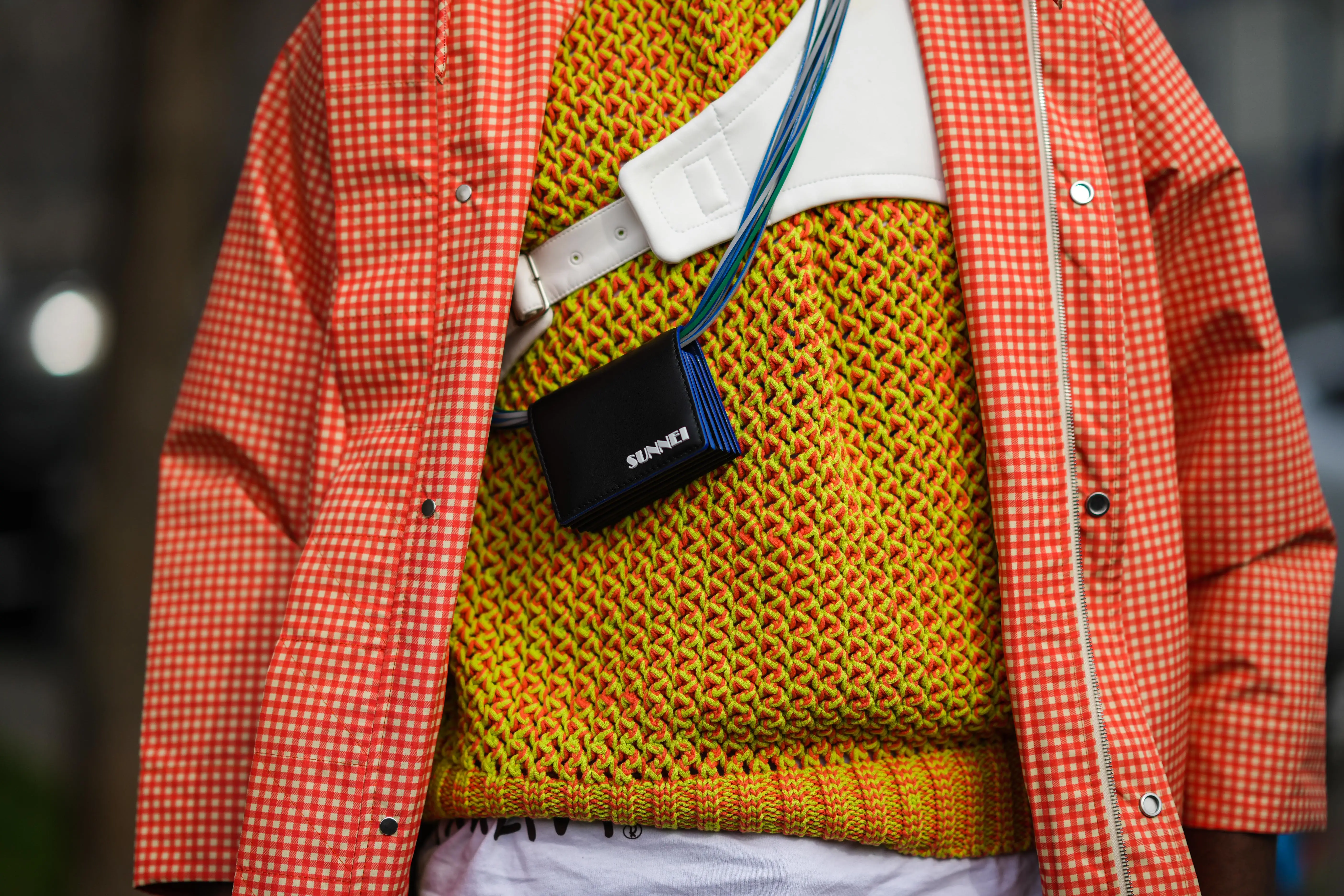 Colorul lime and orange sweater with gingham orange jacket over it