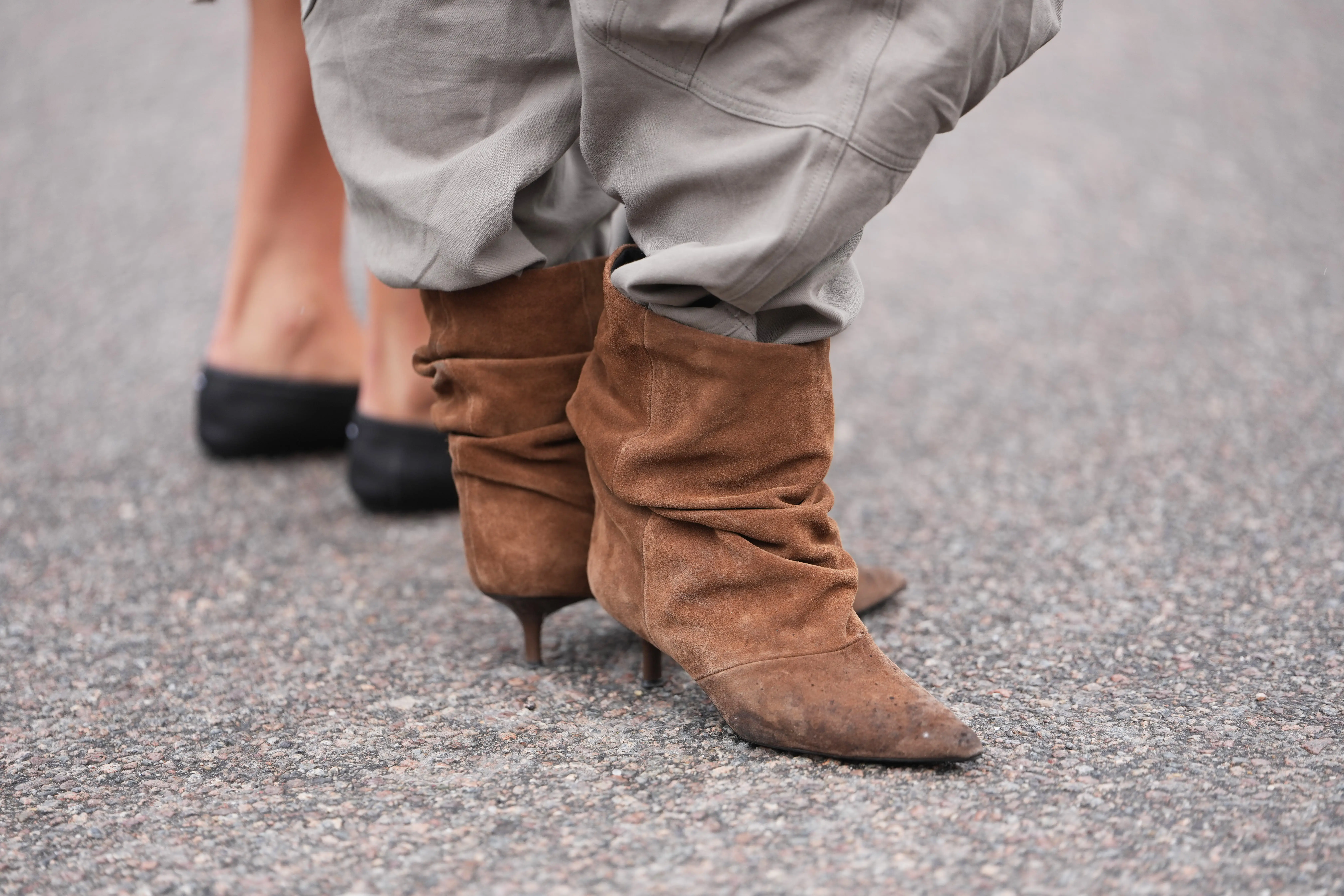 Heeled brown suede ankle boots with pants tucked in