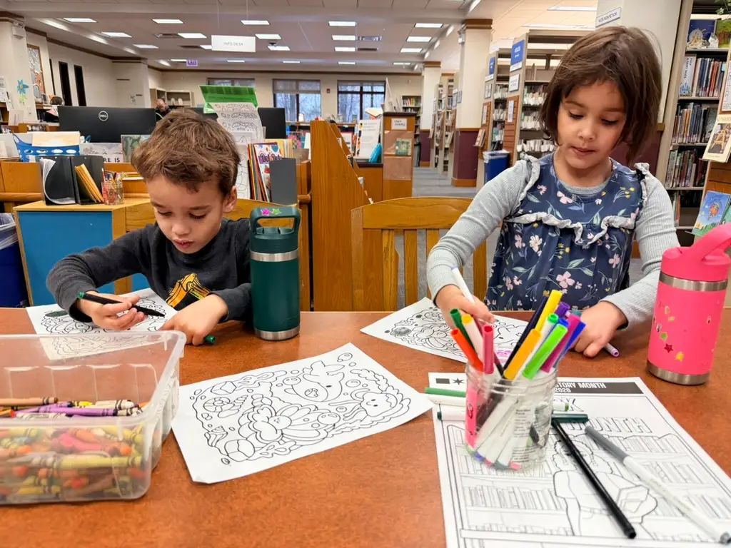 the author's kids coloring at the library