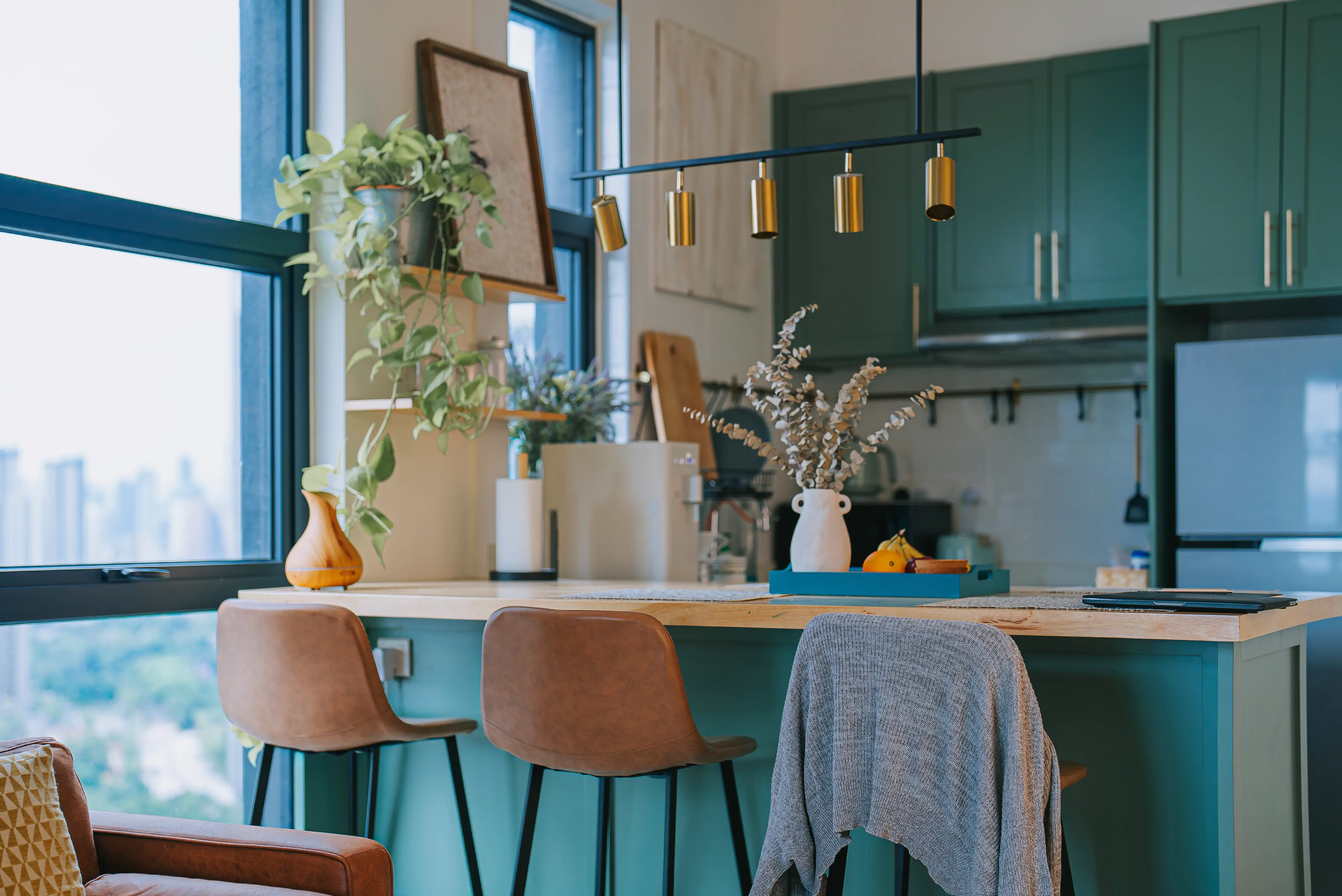 Kitchen with turquoise cabinets, beige barstools