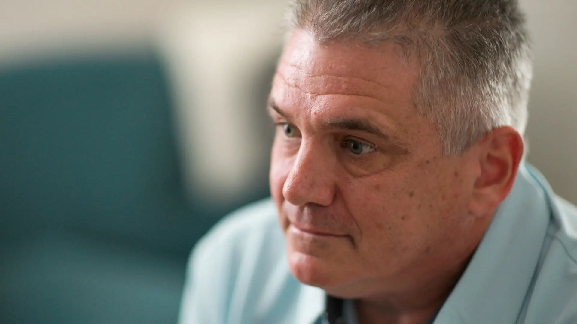 Close-up of Bill Lewis in a blue polo shirt.
