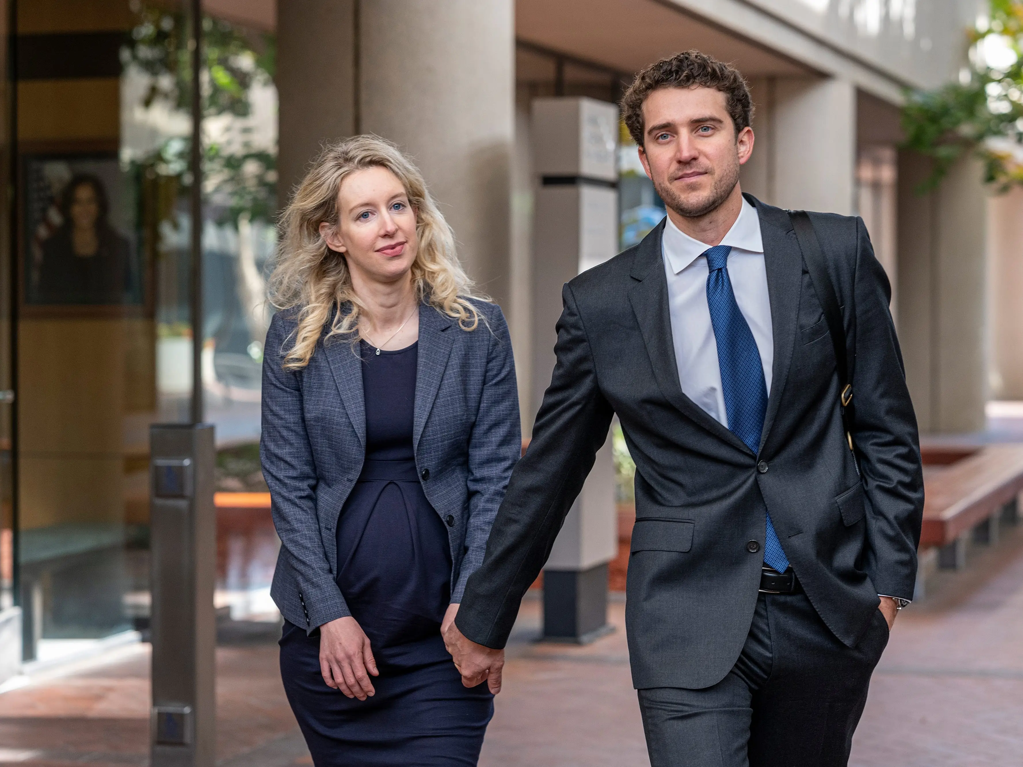 Elizabeth Holmes holds hands with partner Billy Evans.