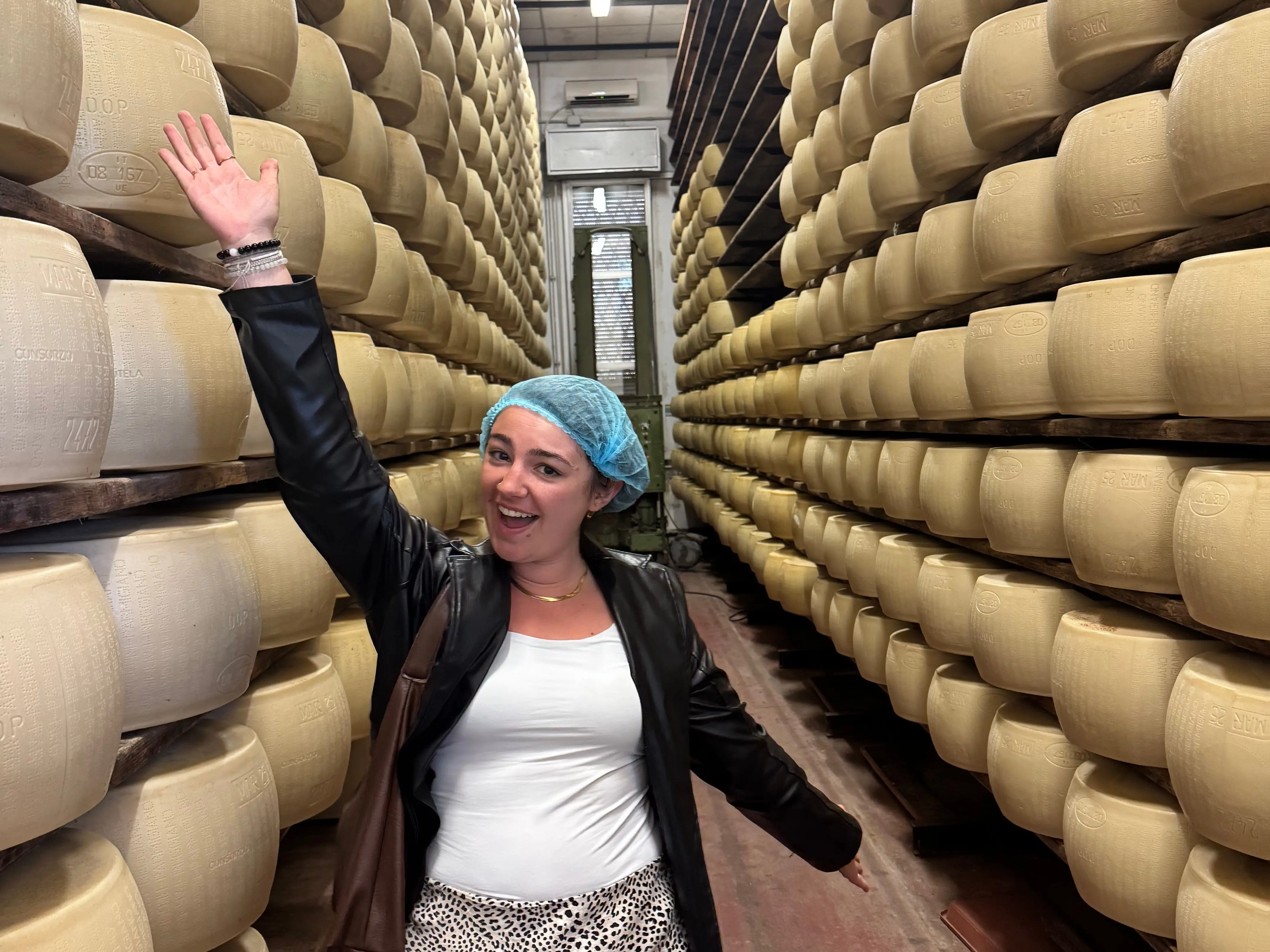 A woman standing at a Parmeggiano Reggiano factory in Parma, Italy.